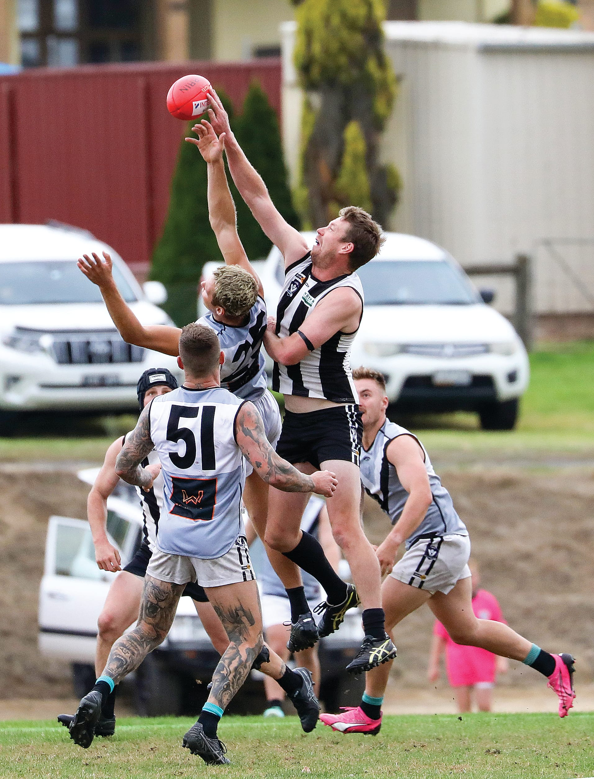 Poowong’s Connor Cunningham gets hands to the ball over his Yarragon opponents in Saturday’s Seniors match. Photo: Jeff Tull.