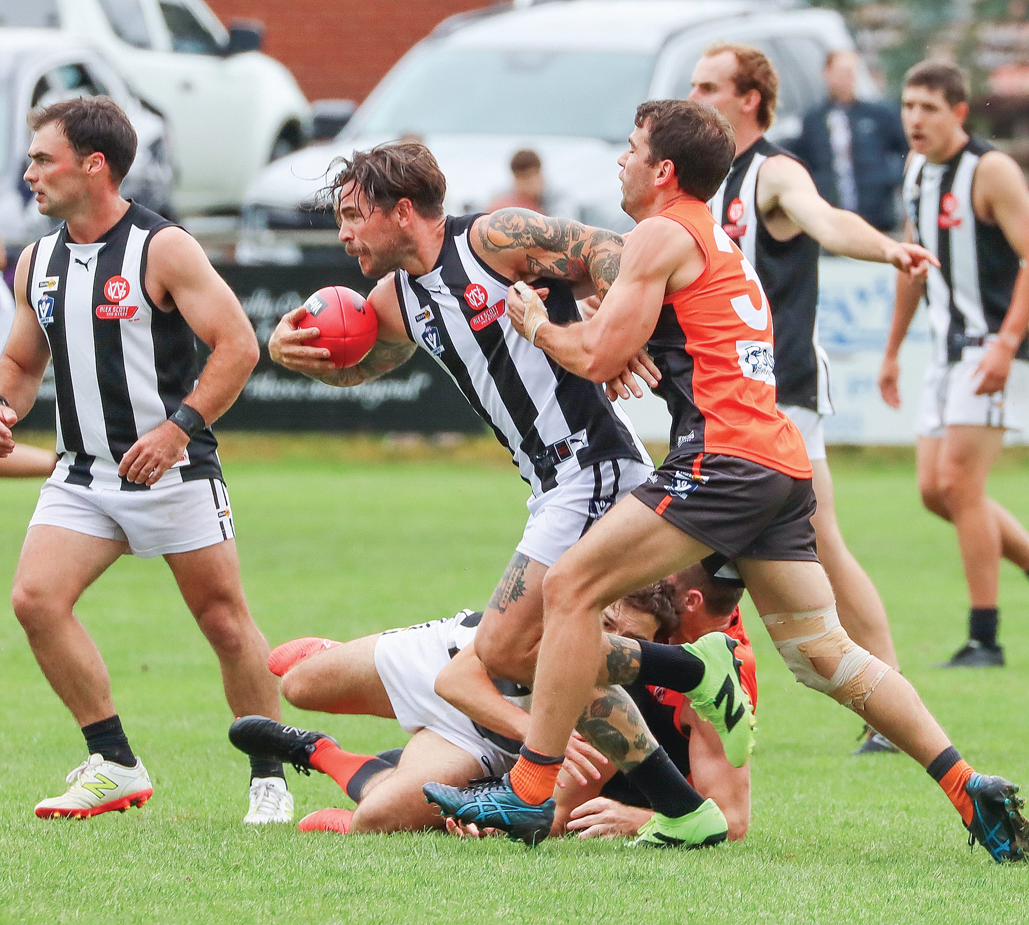 Dalyston’s Kyle Hutchison attempts to bustle his way through despite close Korumburra-Bena attention. A32_1725