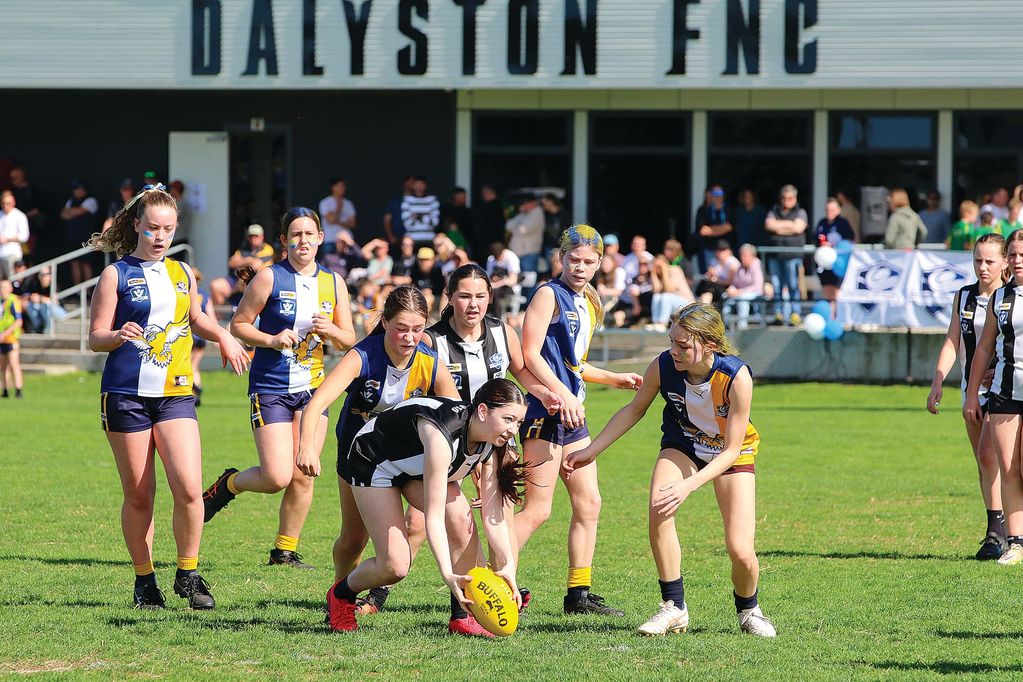 Dalyston’s Matilda Hales keeps the ball in her possession, under pressure from her Inverloch-Kongwak opponents in the U14 girls’ grand final.