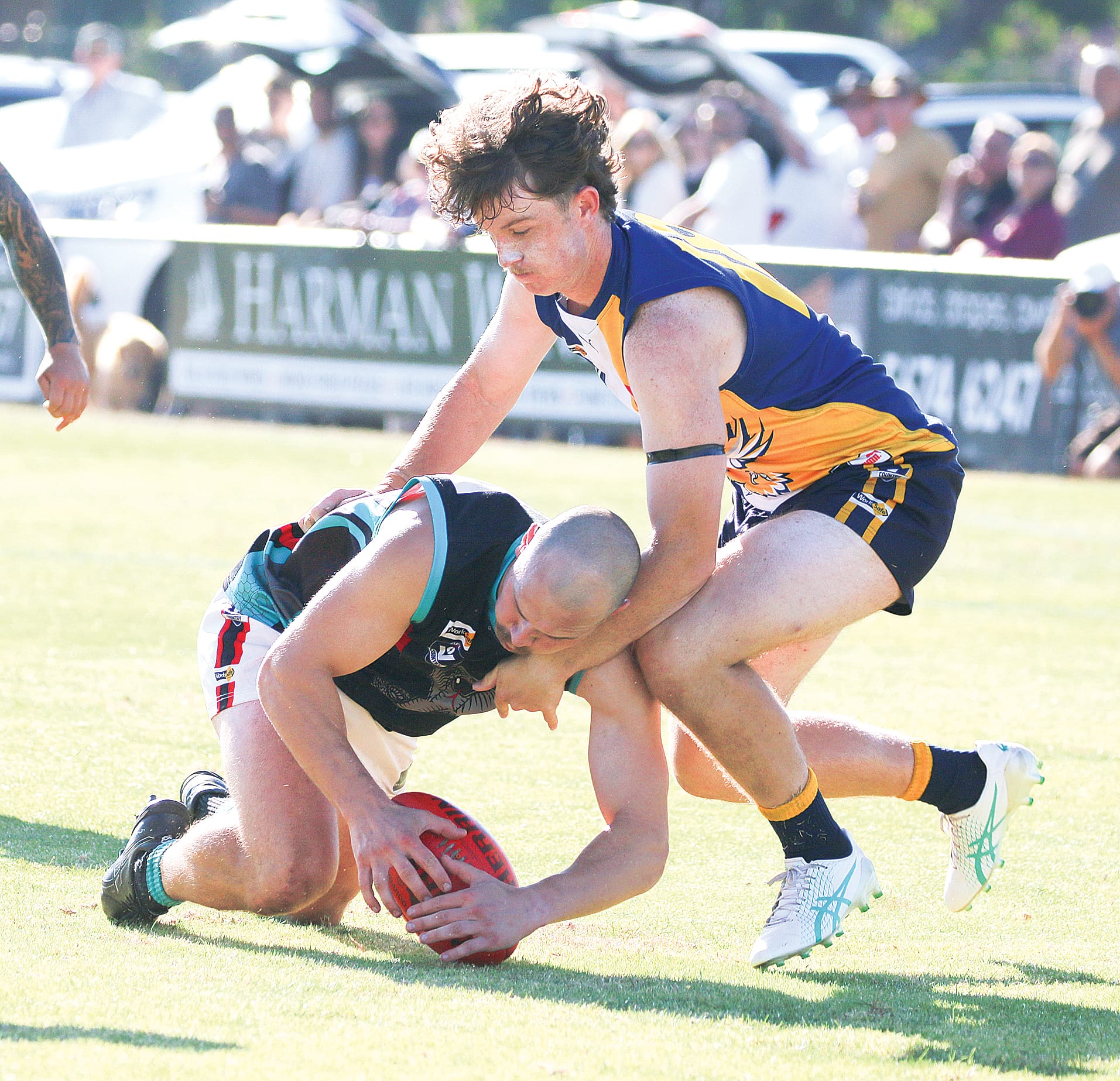 Inverloch-Kongwak’s Jarvis Harvey tries to reclaim the ball from Cora Lynn’s Matthew Briggs.