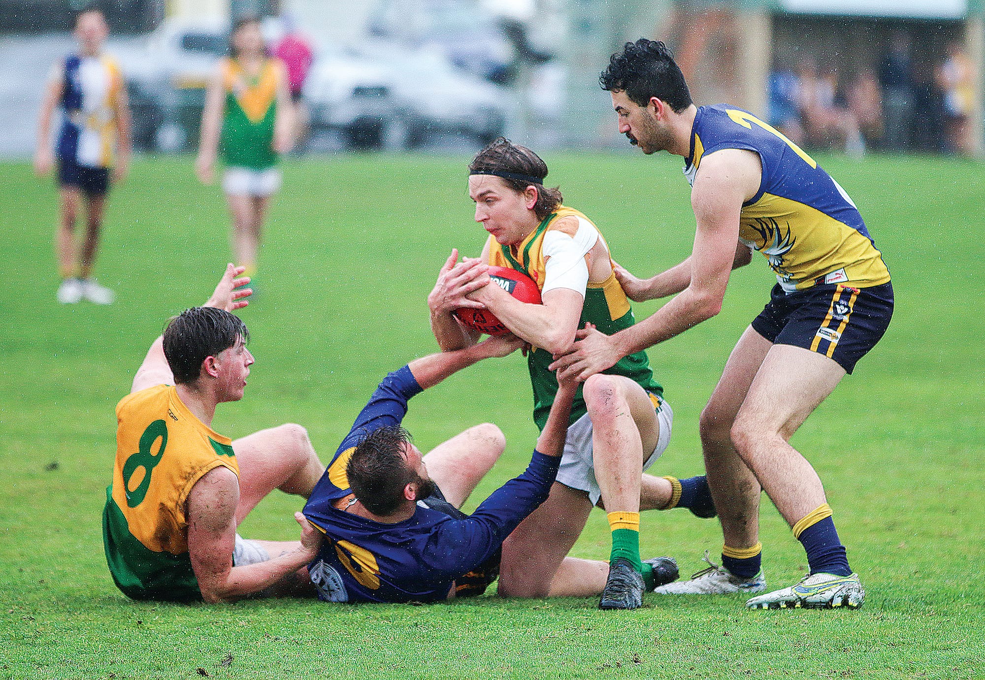 Garfield hangs on to the ball, under pressure from Inverloch Kongwak’s Tom Hams and Oscar Toussaint.