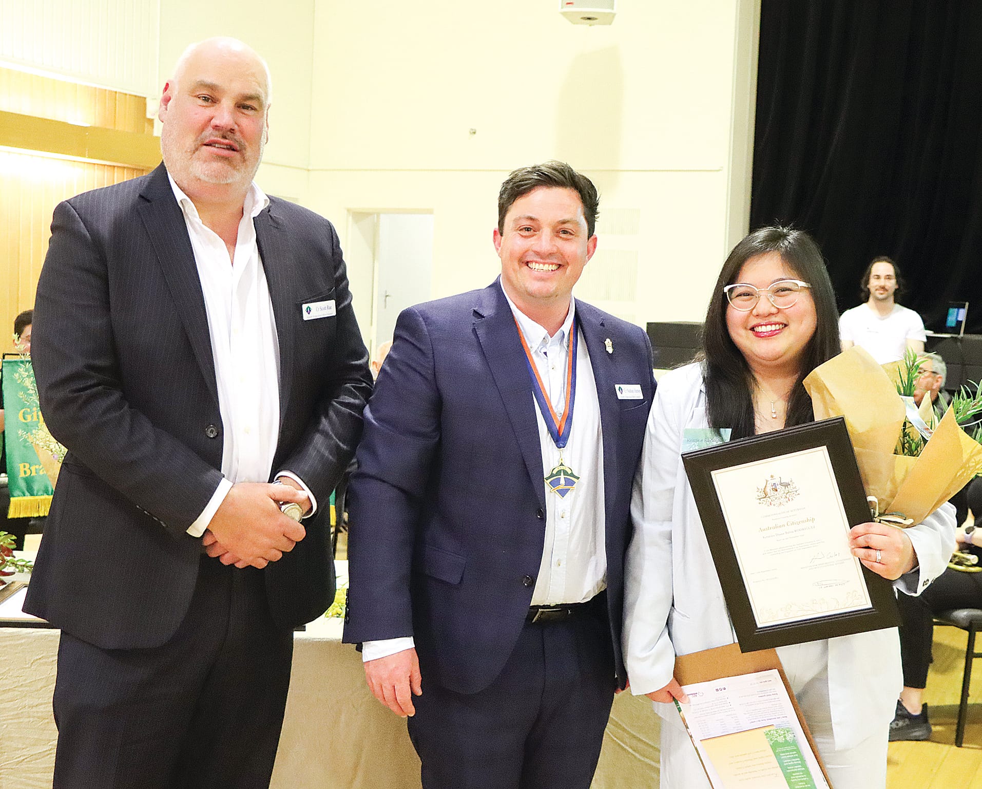 Kristine Rodriguez from the Philippines celebrates becoming an Australian citizen, enjoying the moment with Cr Scott Rae and mayor Nathan Hersey. A07_3823