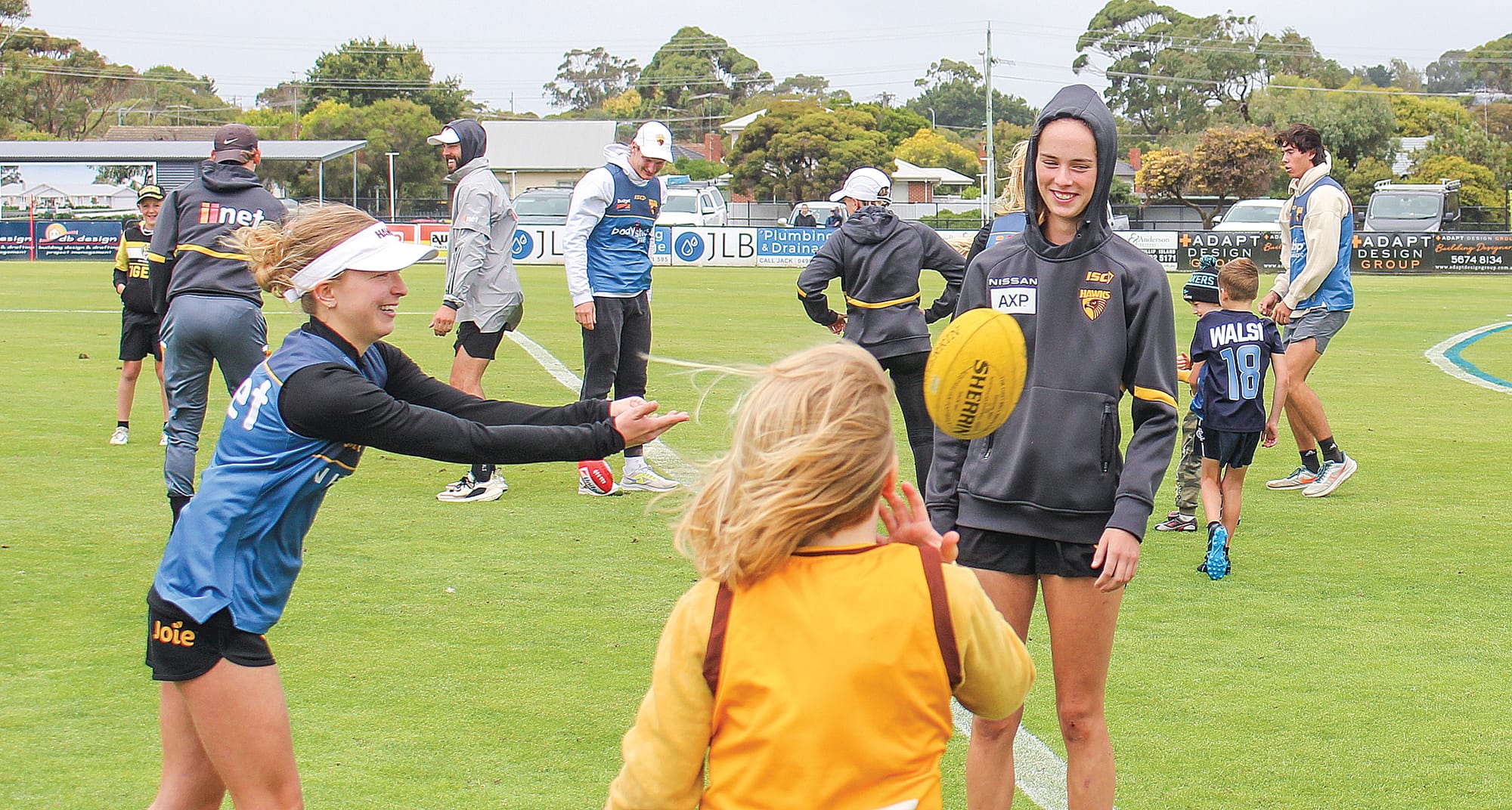 Local star Sunday Brisbane of Phillip Island handpasses to a youngster during last year's Box Hill Hawks clinic. B01_0623