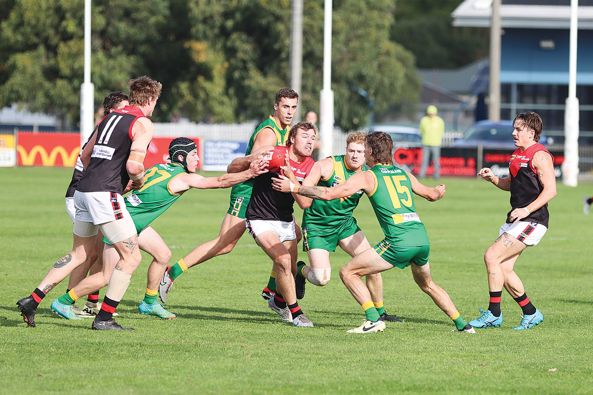 Leongatha players apply their trademark pressure, with Ned Hanily, Matt Borschman and Aaron Turton descending on a hapless Warragul opponent. A13_1924