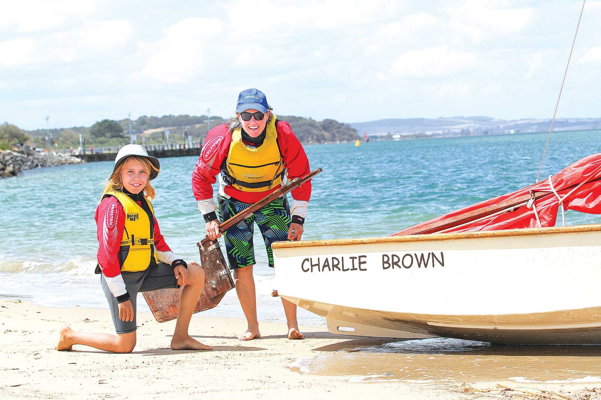 Clancy and her mother Lucy fixing a broken rudder on wooden dinghy Charlie Brown B78_0725