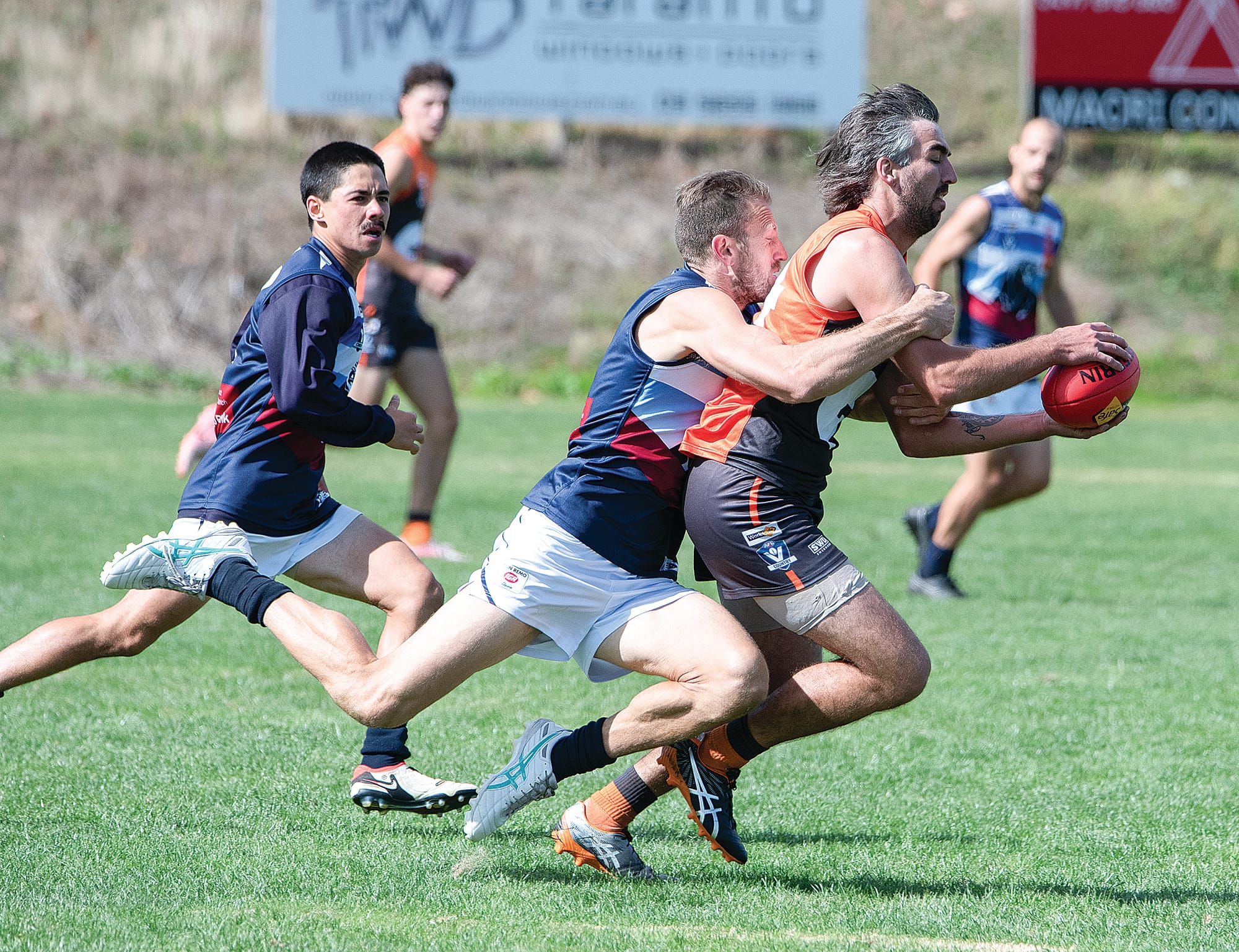 Travis Tuck runs down Aidan Simmons, and applies the tackle to win the ball for Kilcunda Bass.