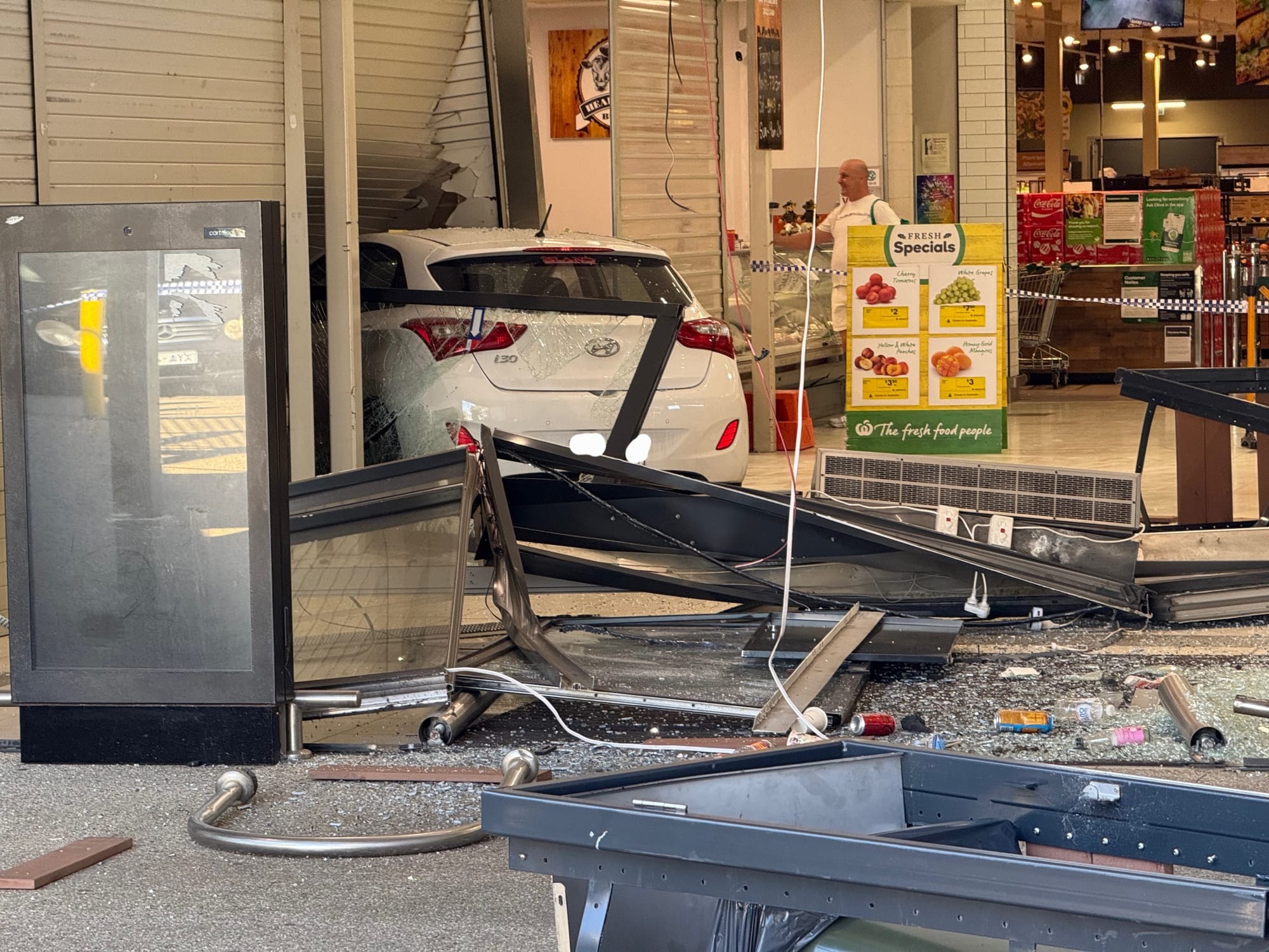 Narrow escape for Woolworths employees as car smashes through shopfront