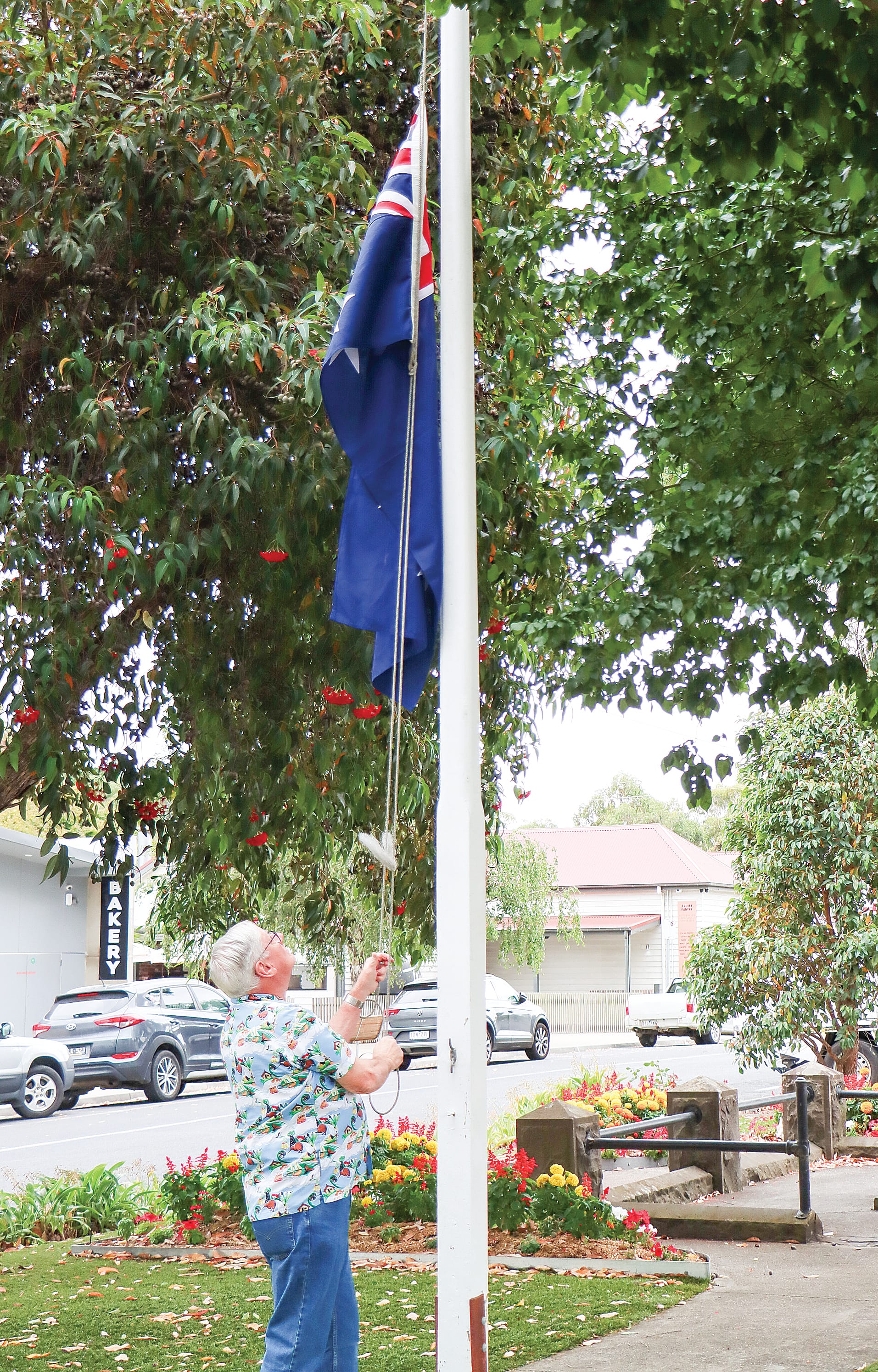 Richard Powell raises the Australian flag to commence celebrations of the national day in Meeniyan. A16_0425
