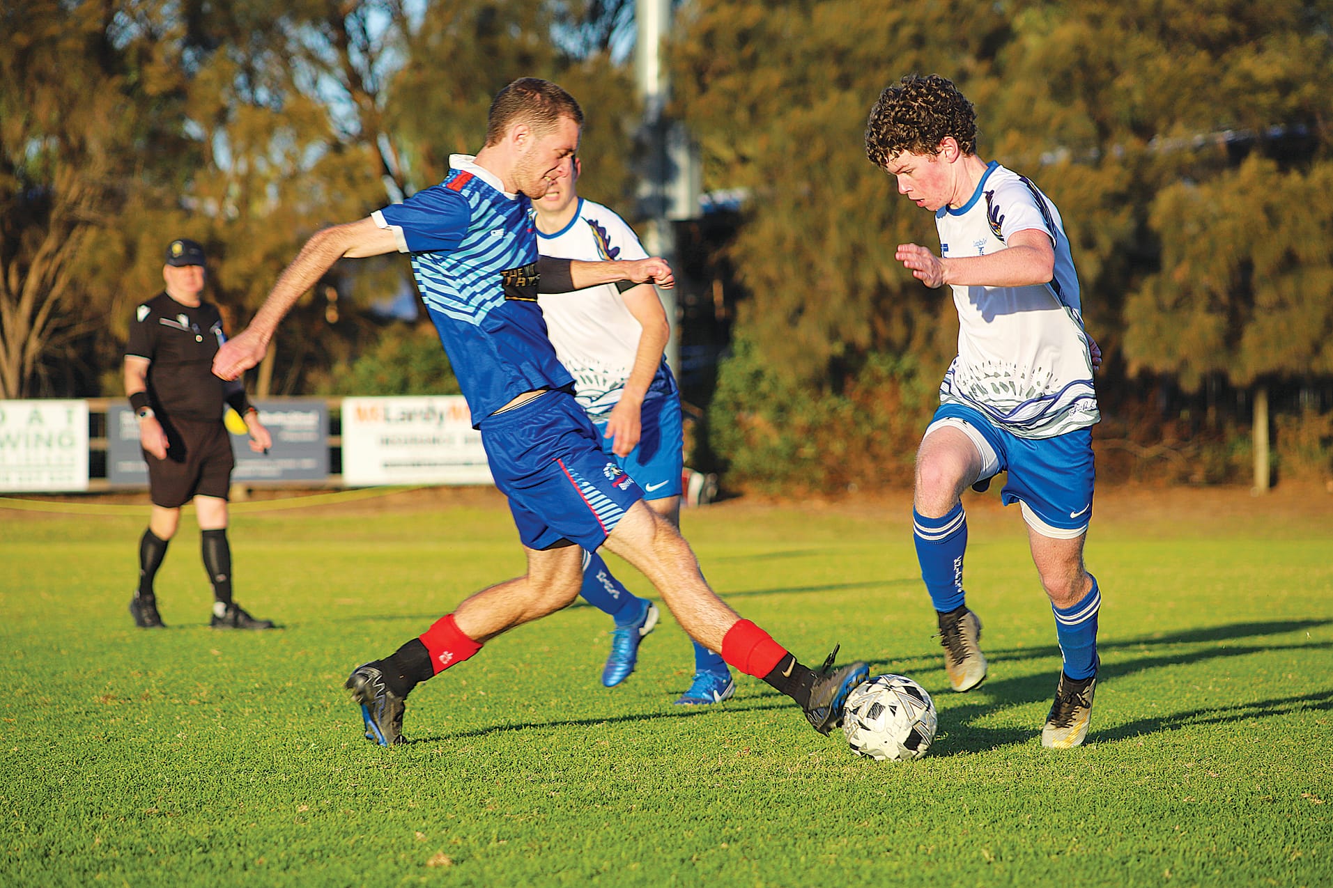 Phillip Island’s Centre Back Jack Middleton moves to shut down Leongatha’s Patrick Wilson in midfield. 