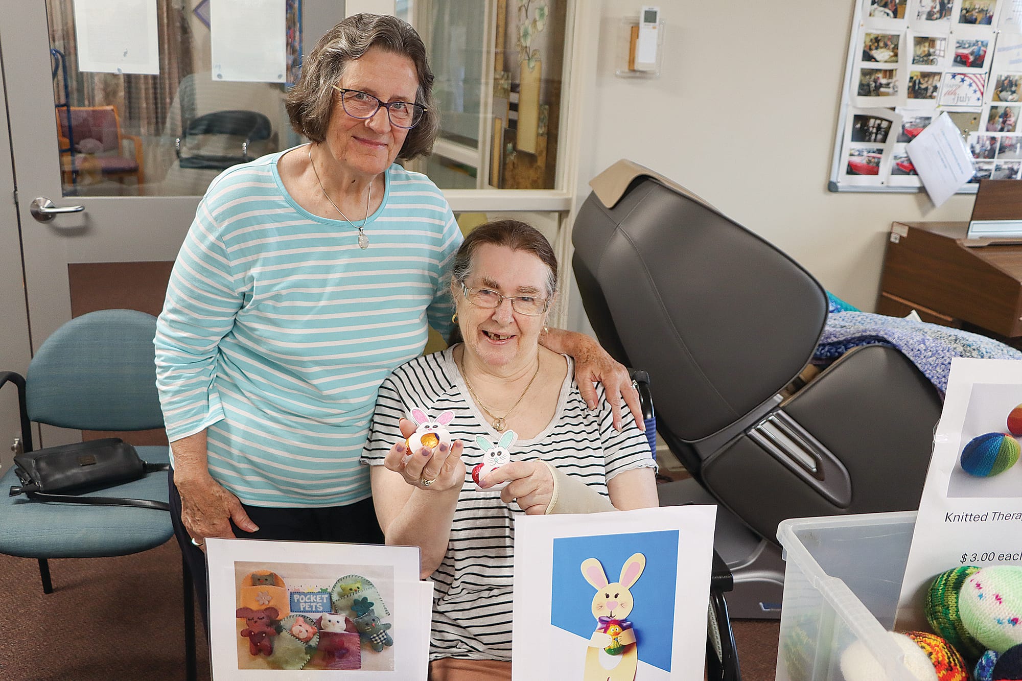 Volunteer Carolyn Richards and resident Lynne McKenzie are ready to welcome more shoppers at the Rose Lodge Fete, Lynn displaying some of her handiwork. A32_1325