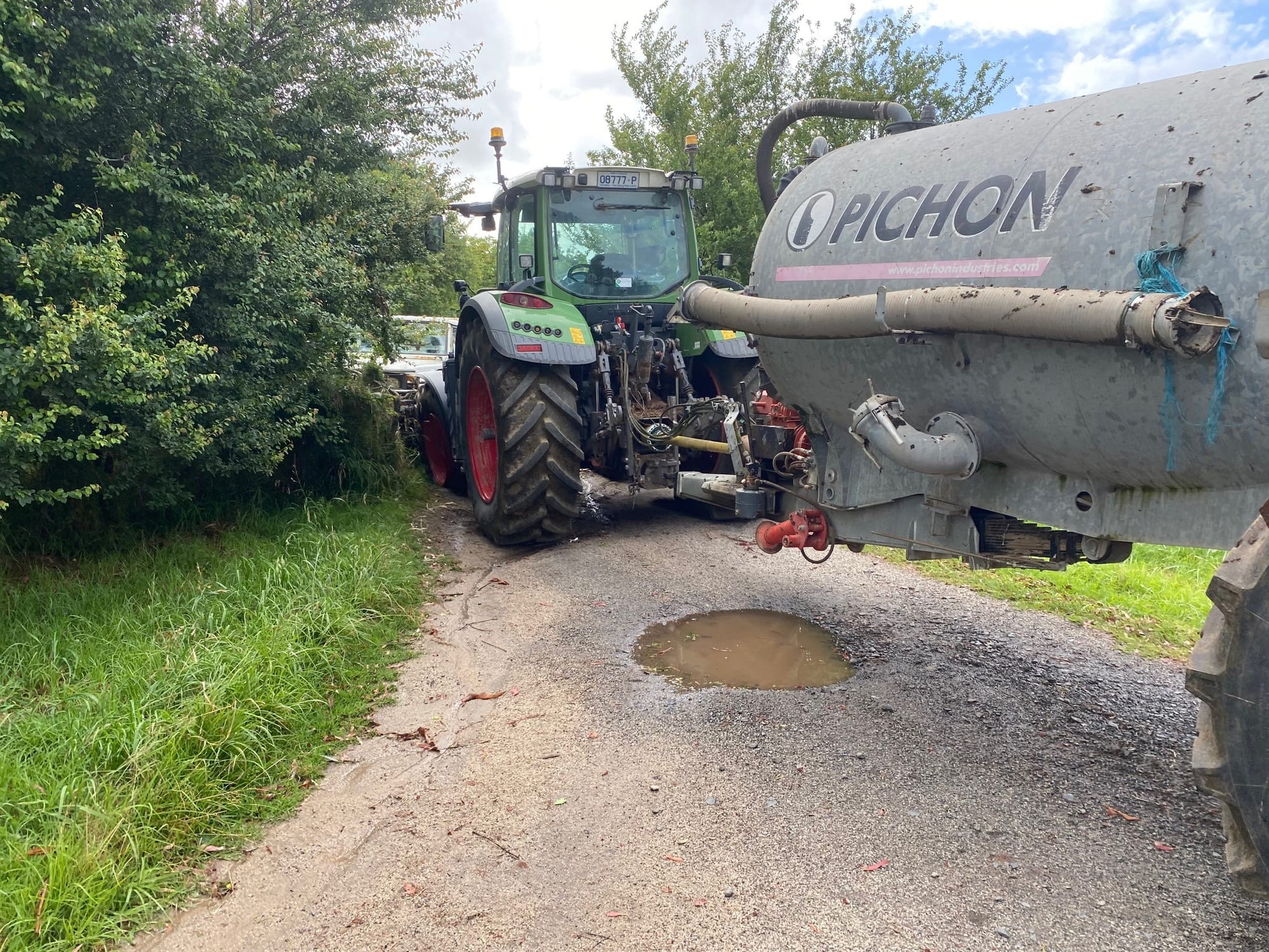The powerful tractor, which was towing an effluent trailer, was jolted backwards by the force of the second collision.