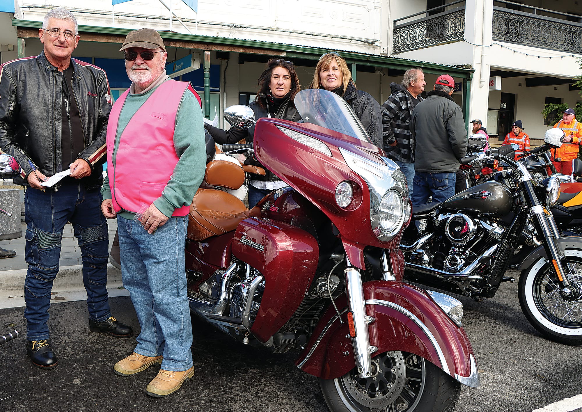 Brent Robinson enters the Biketoberfest raffle, with volunteer Ken Wanklyn selling tickets.  Robyn Robinson and Eva De Rango are behind the stunning Roadmaster motorcycle.


