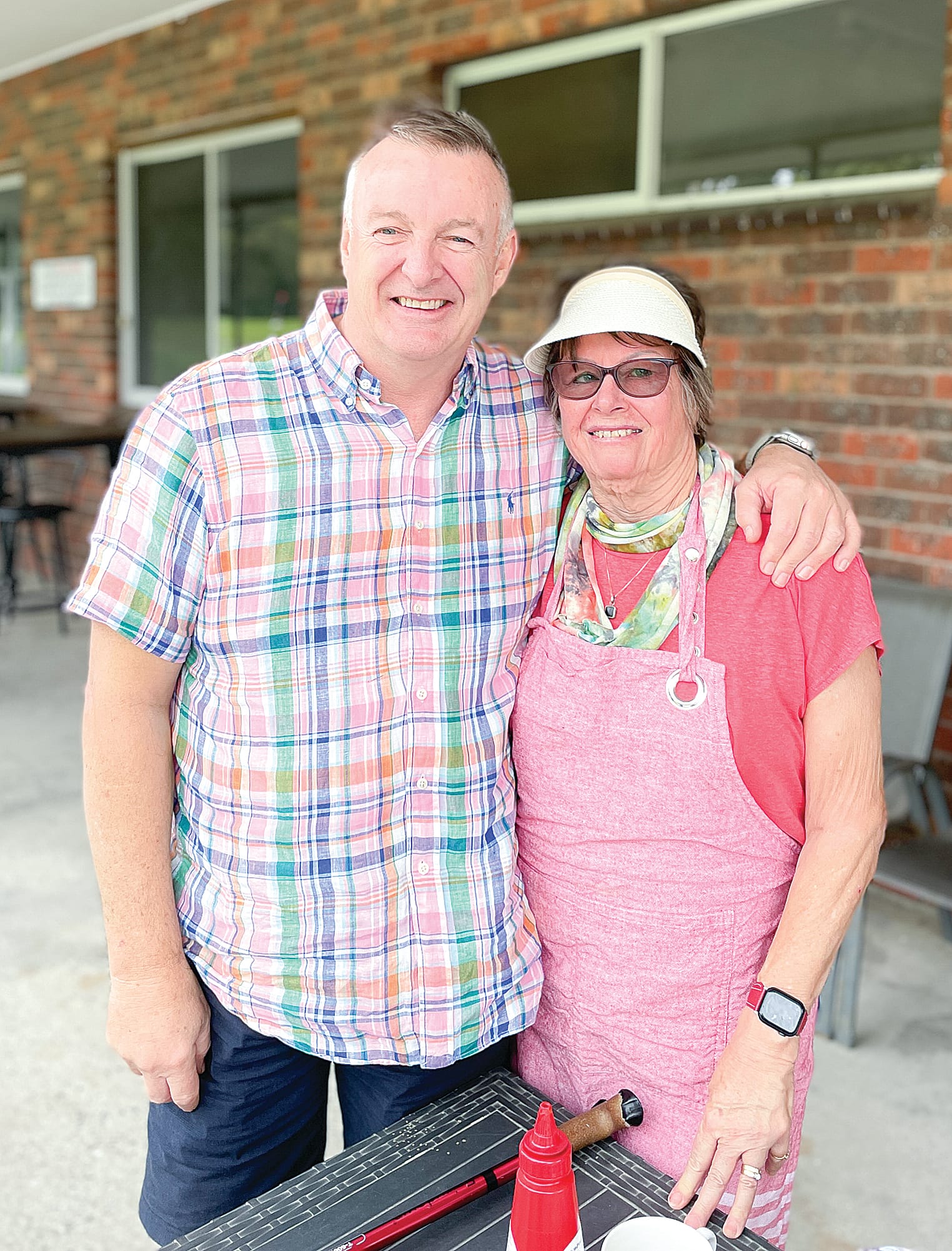 Go Girls Charity Golf Day convener Craig Jobson and head of the barbecue local volunteer from Foster Vanessa Searell at the Leongatha Golf Club.