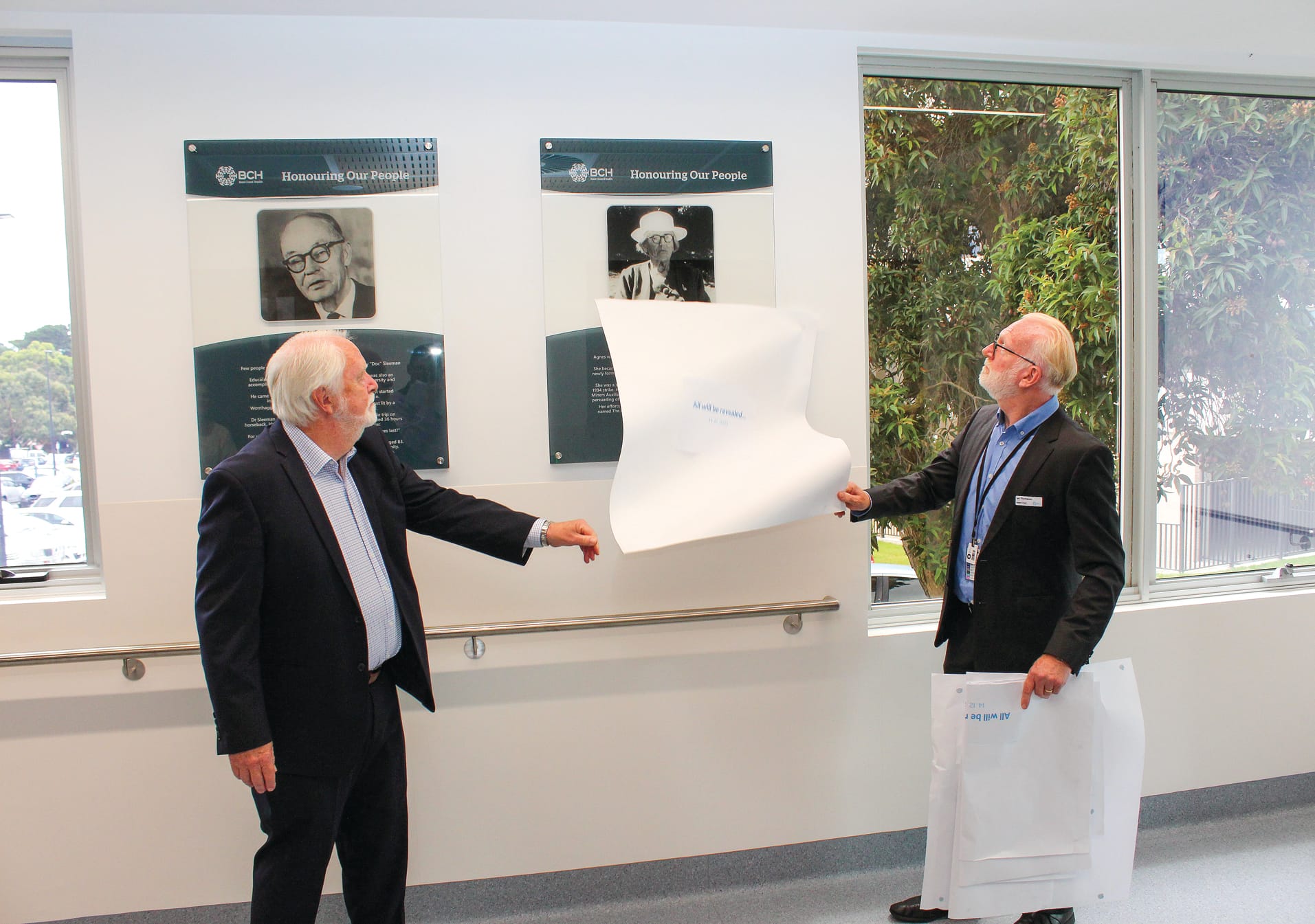 Former Bass Coast Health Chair Don Paproth and Chair Ian Thompson reveal the honour board recognising Agnes Chambers.