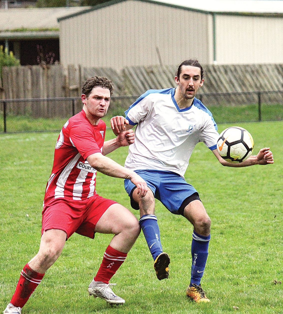 LKFC’s Mitch Bath wins the ball over his Trafalgar opponent. 