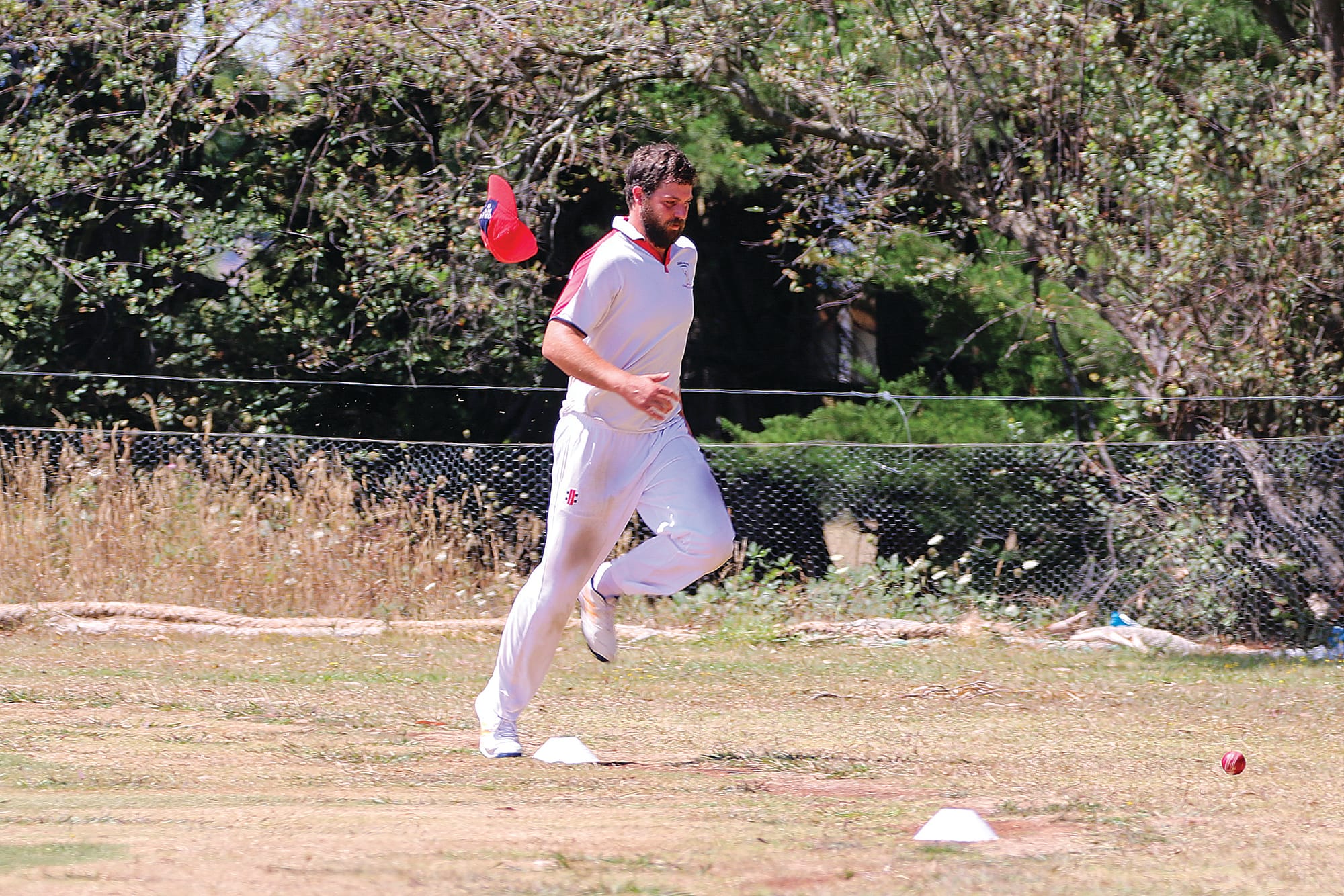 The hat came flying off as Daniel Gilbert attempted to intercept a four. C49_0525