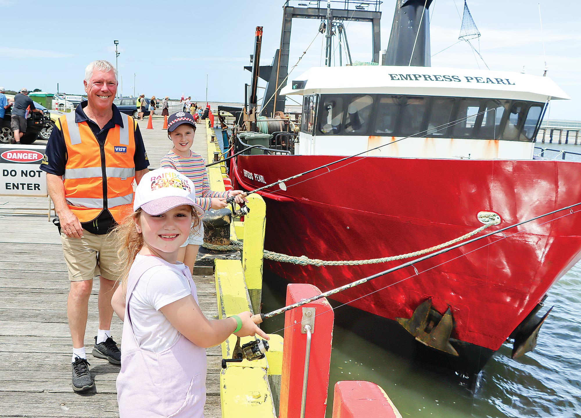 Brylie and Heidi Hamilton of Fish Creek work on their fishing skills, with Robin Street on hand to answer questions. A35_0224