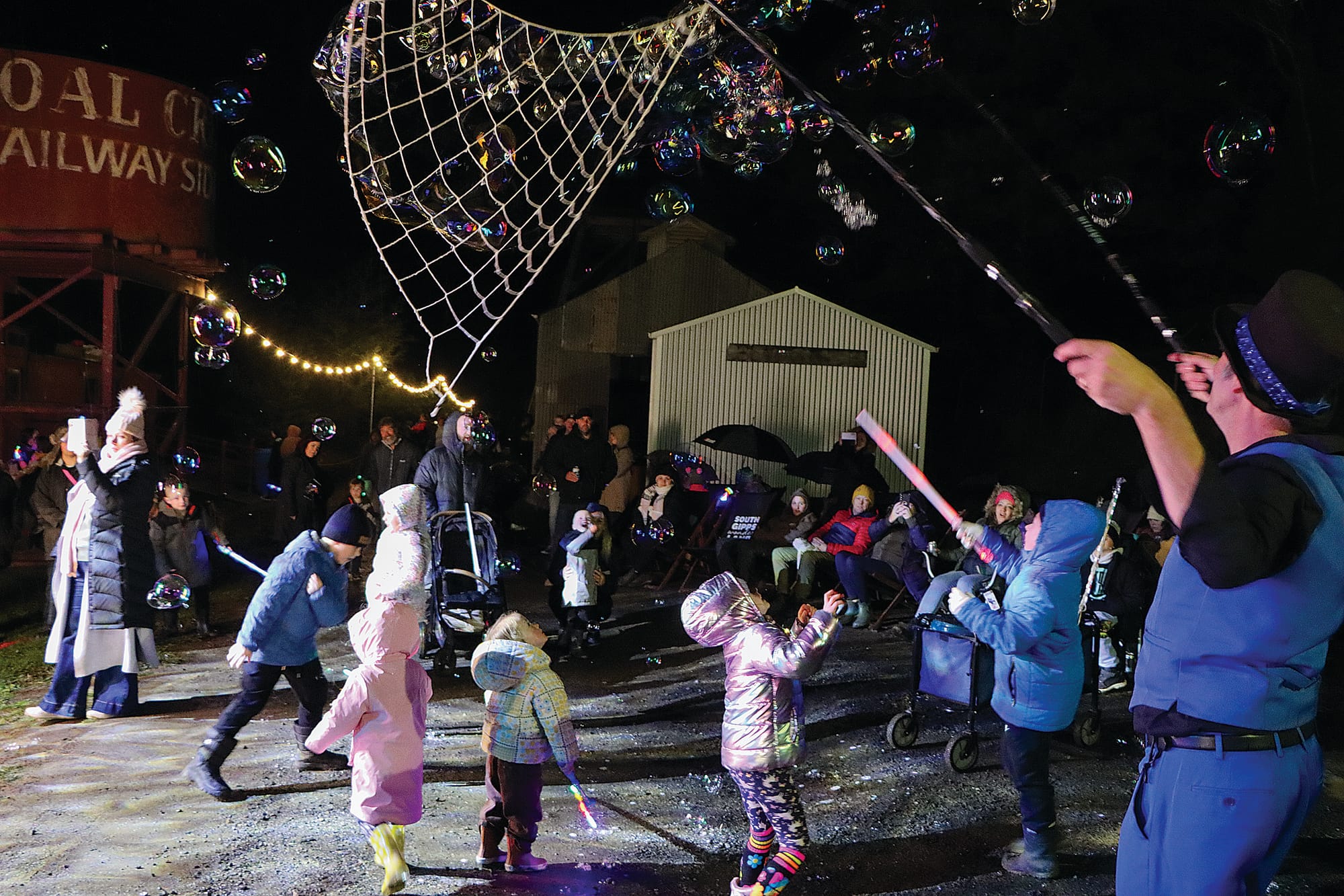 Young attendees are spellbound by bubbles at the Southern Lights Festival. A45_2325