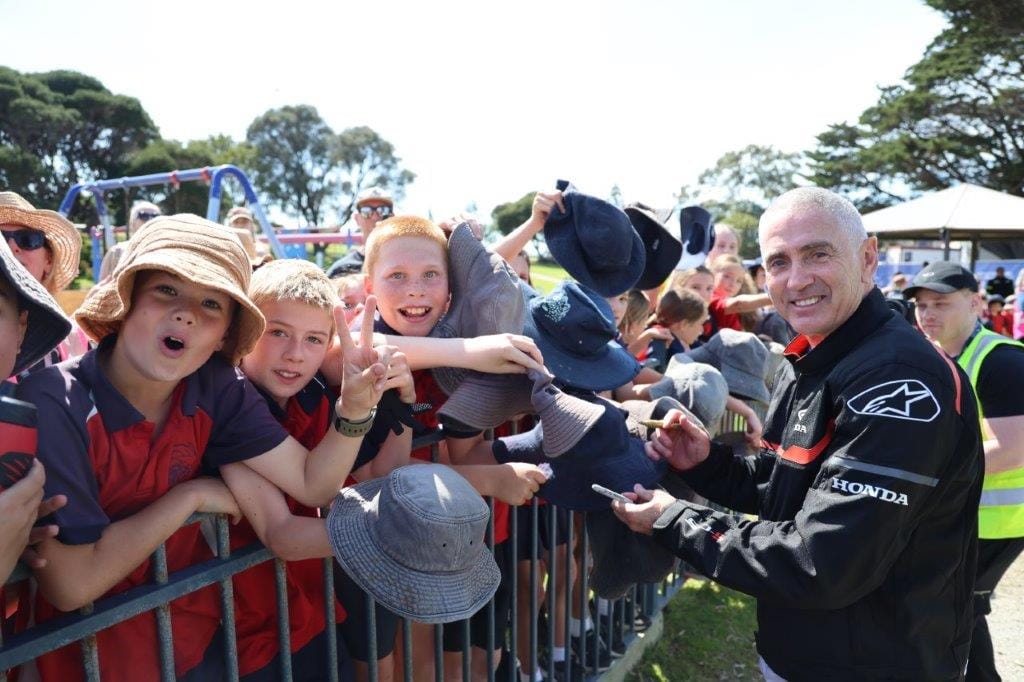 Aussie legend Mick Doohan signs autographs and poses for selfies with the kids from the San Remo Primary School on Thursday prior to leading the ‘Home Coming Ride’ to the world-famous Phillip Island GP Circuit ahead of the official start to racing on Friday and the great race on Sunday.