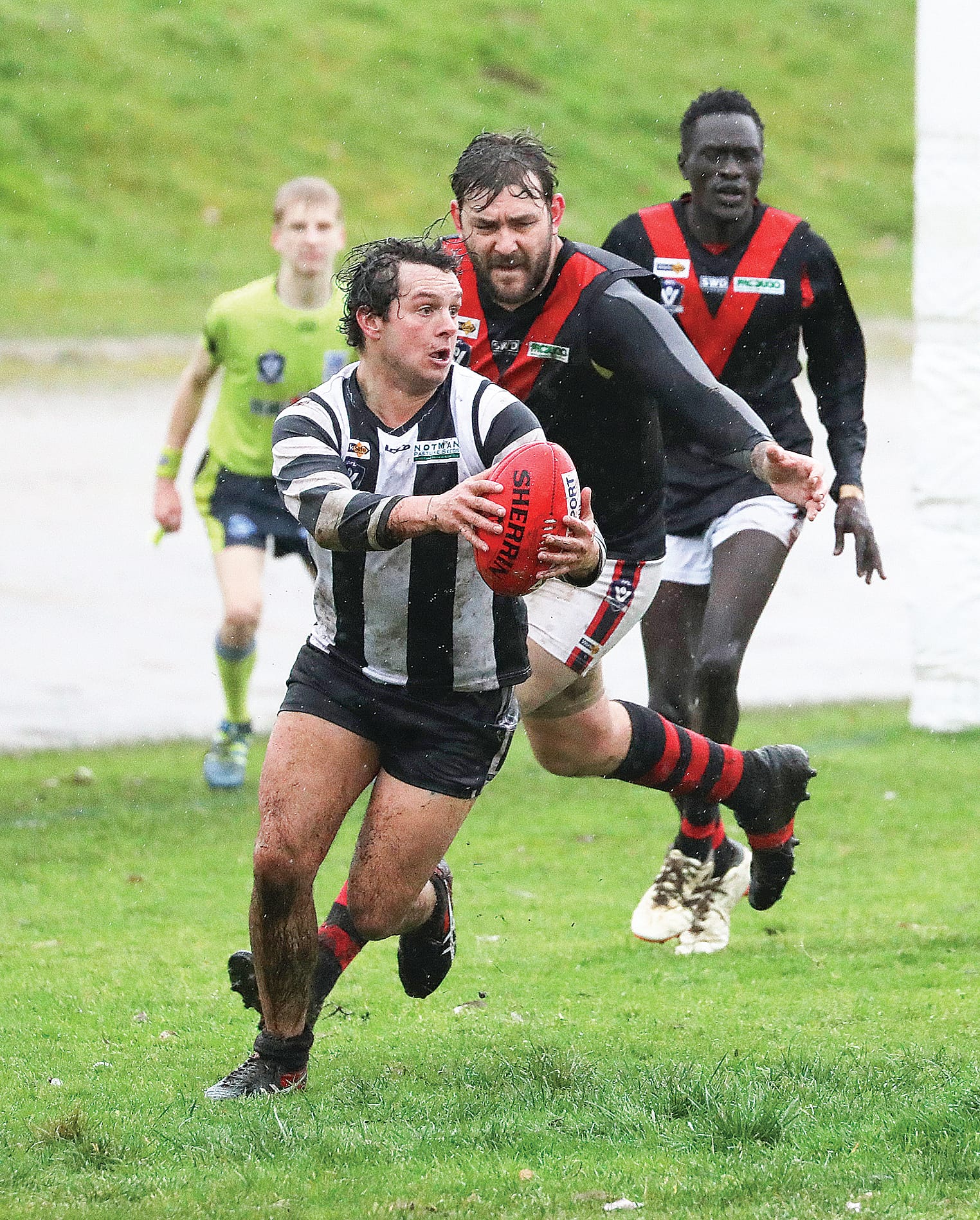 Josh Chiavaroli looks for an opening in the rain-soaked clash. Photo: Jeff Tull.