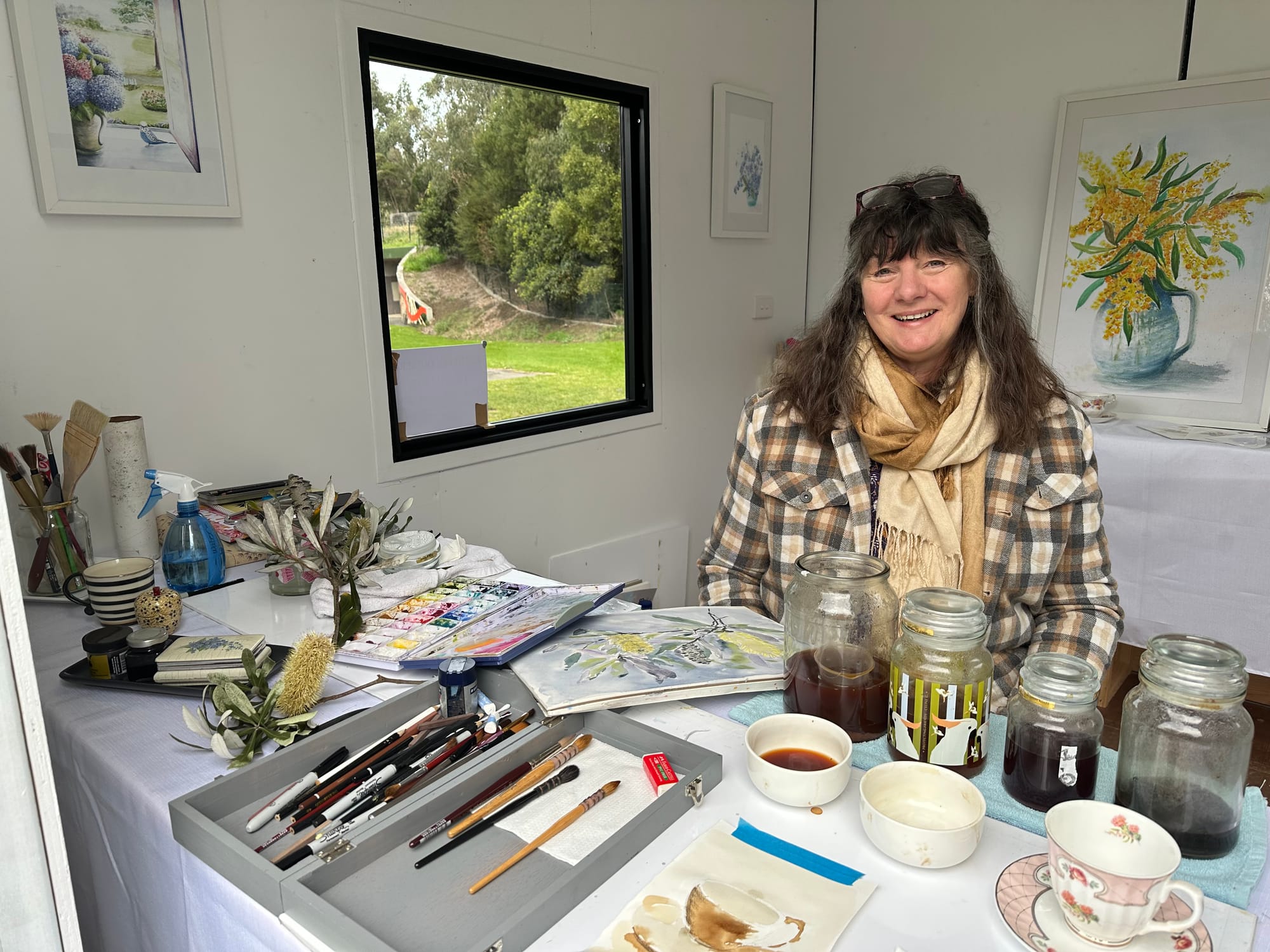 Kath Quinert is painting water colours in one of the art cubes in Loch and is inviting people to come and create a small painting out of a tea washes.
