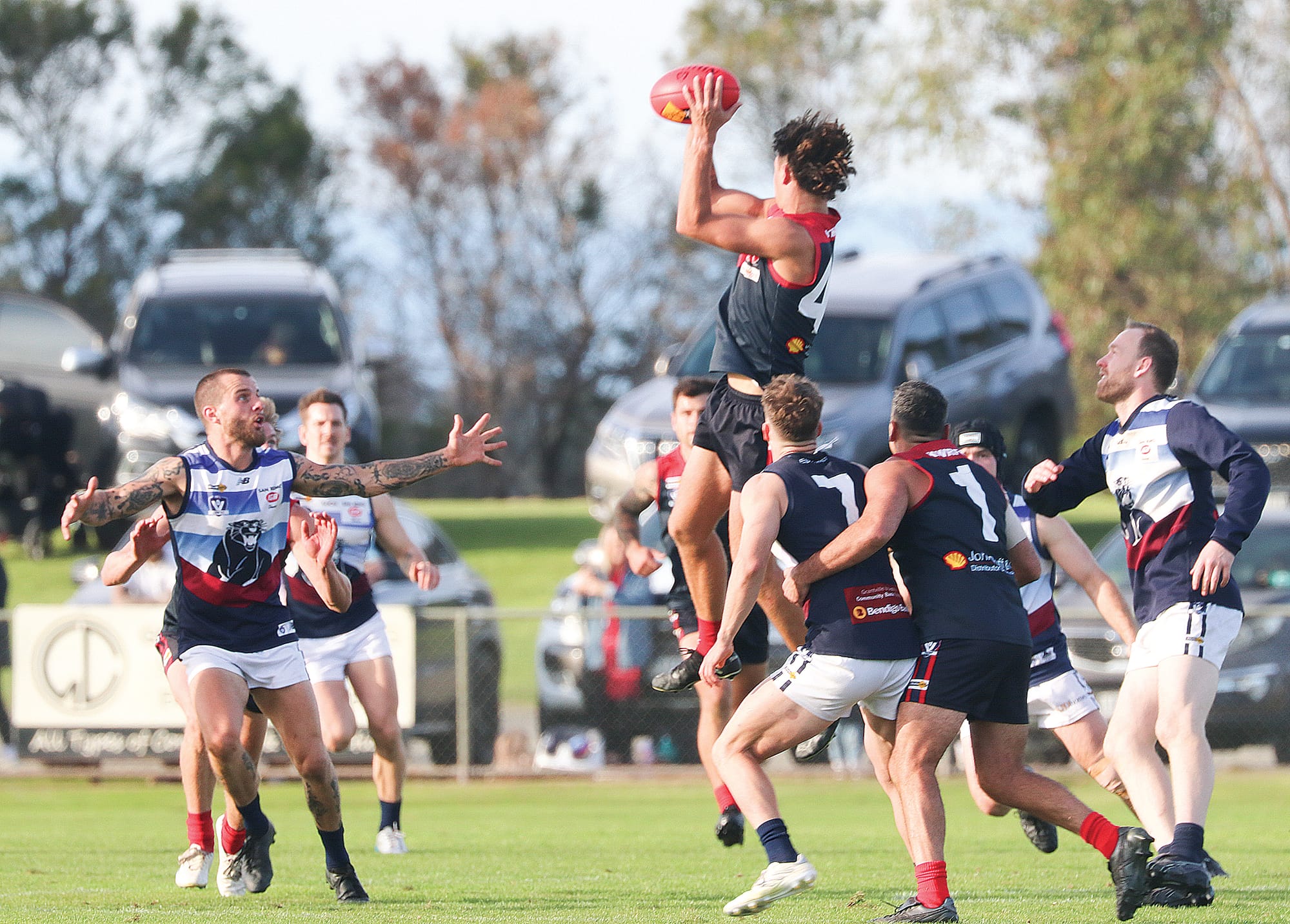 Matthew Voss of Koo Wee Rup leaps and takes a mark against the defensive panthers. Z42_1924 