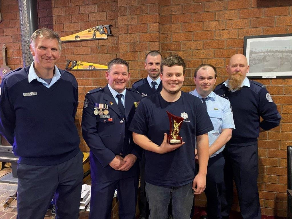 Josh Hillman is surrounded by his Mirboo North CFA mates as he receives the annual ‘Steve Groen Memorial Encouragement Award’ last Saturday night.