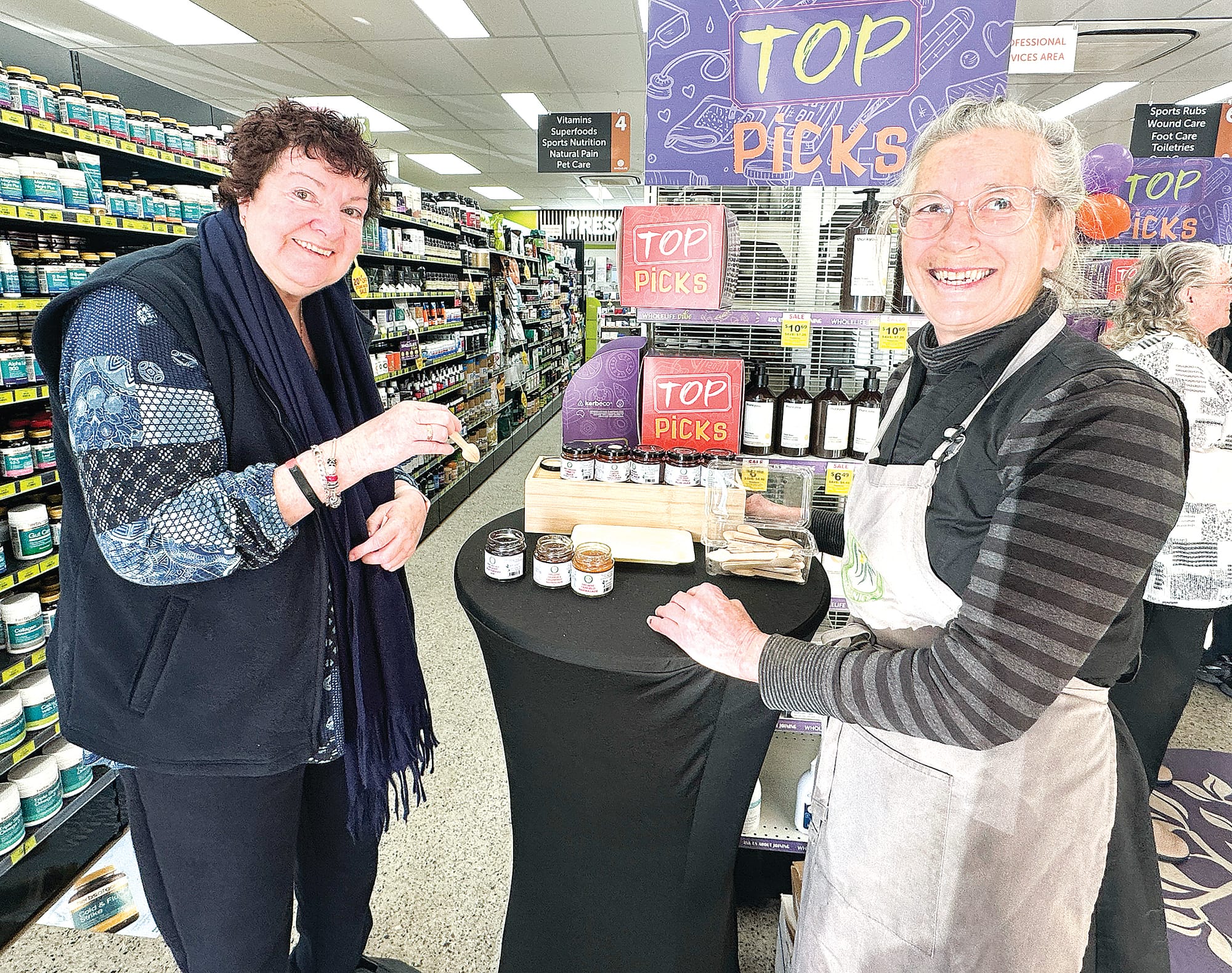 Joan tastes some of Rosie’s local jams and sauces, which are sold in store at Mirboo North Pharmacy. ob09_2925