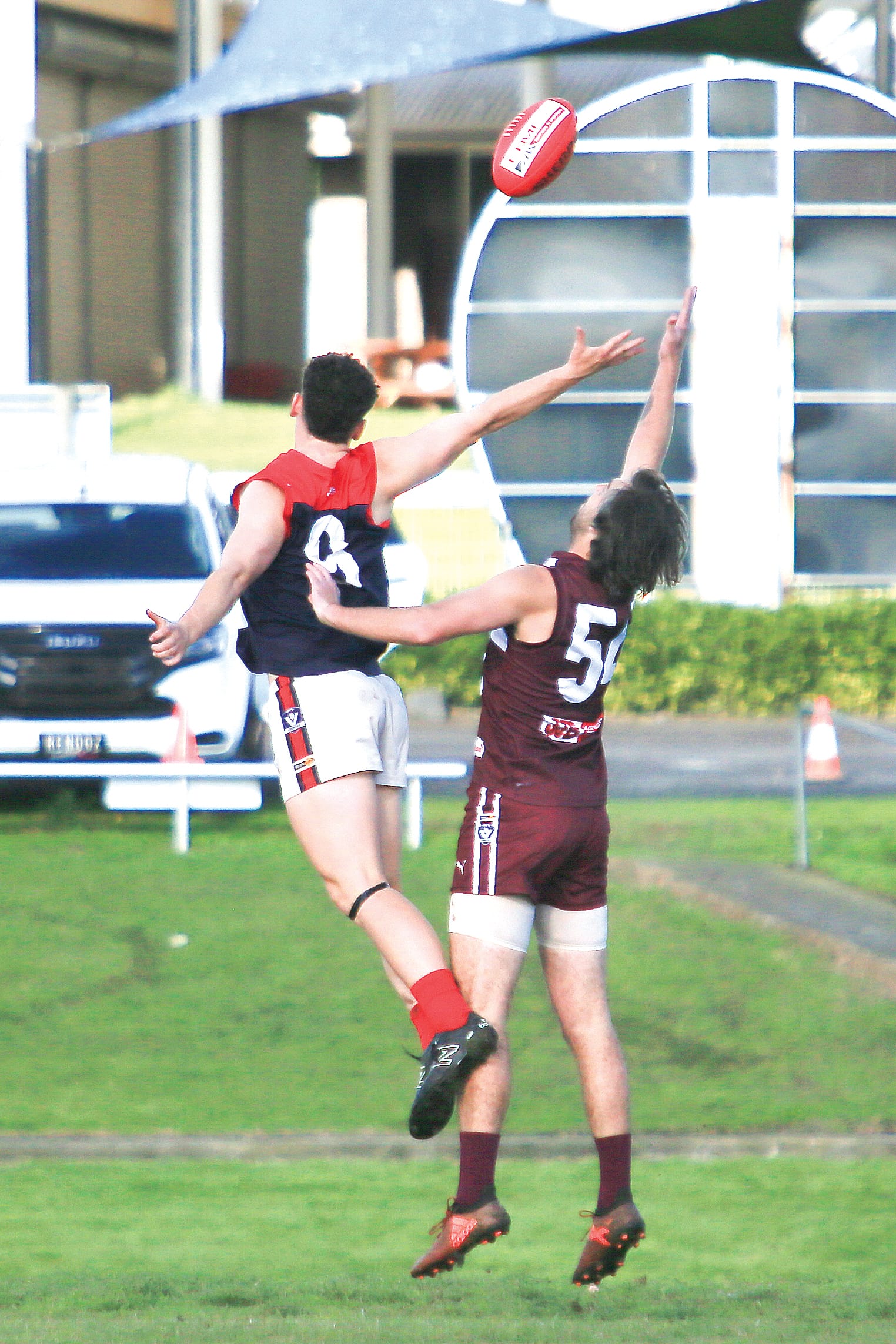 Aiden Simmons is geared up to receive the ball behind his Boolarra opponent. Photos: Gerard Bruning.
