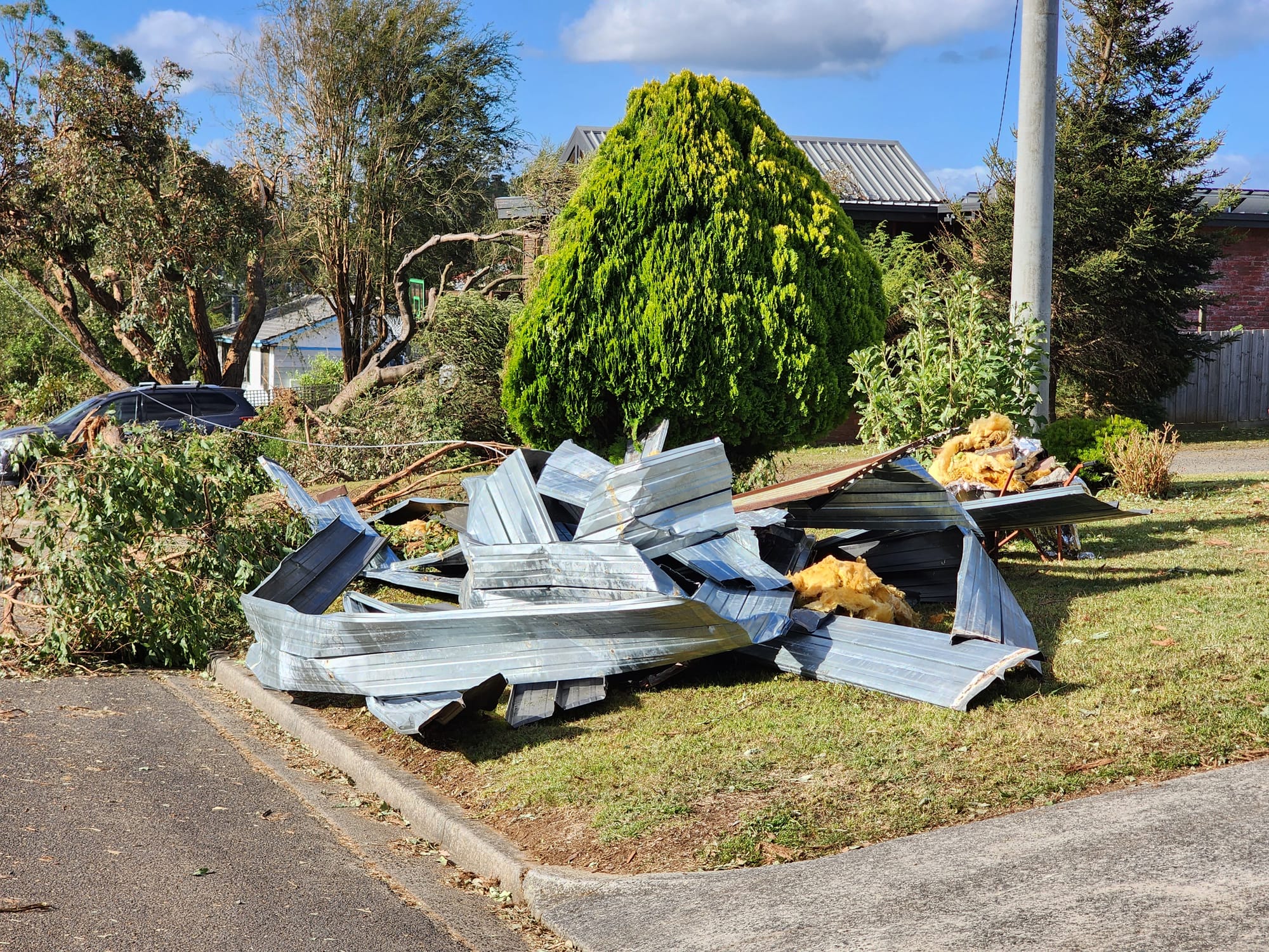 Pam's roof sits on her front natures strip in pieces.