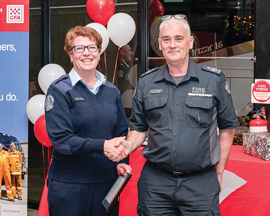 CFA Catchment Commander Gavin Parker presents a five-year service award to Jenni Denney.