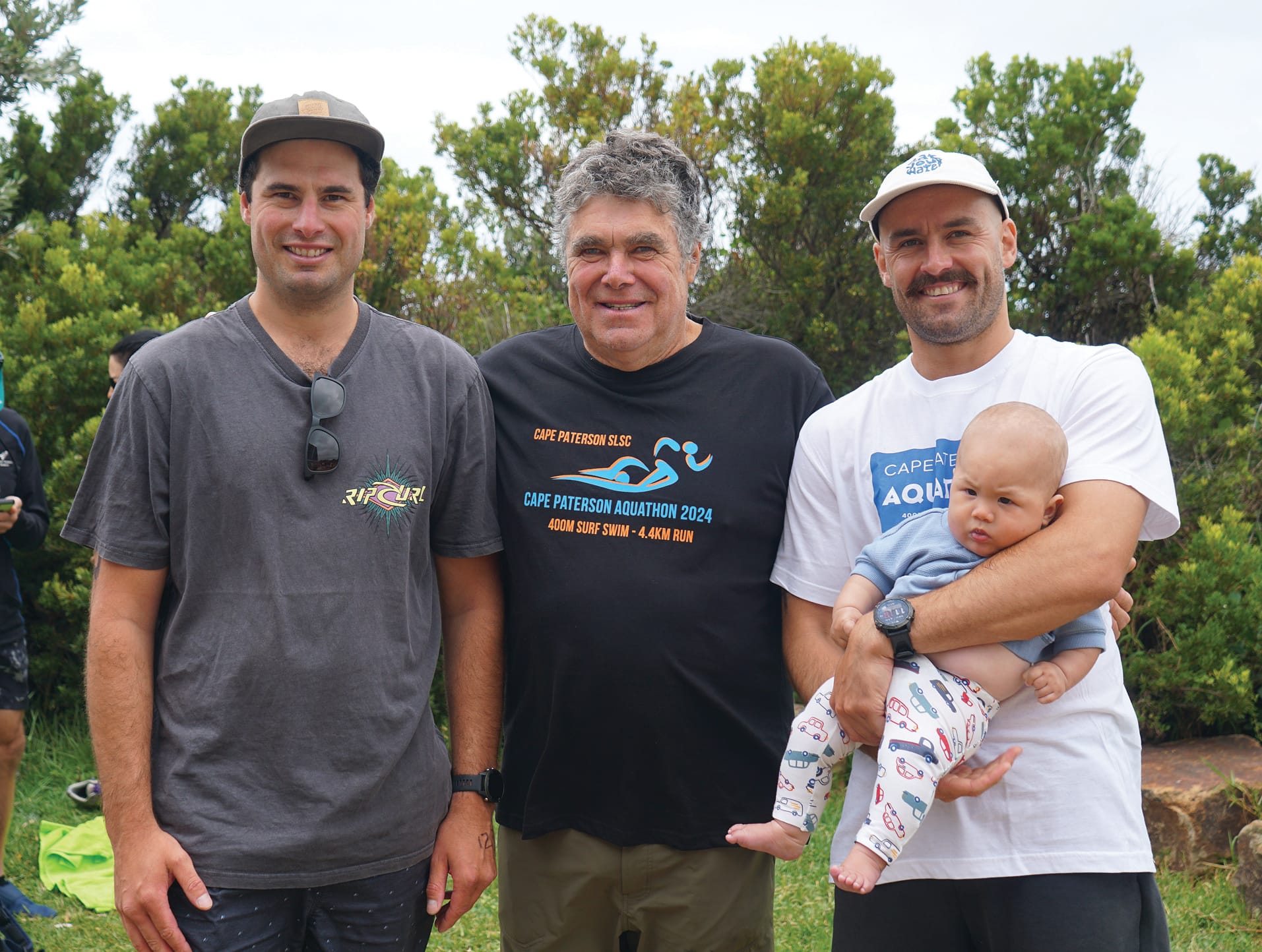 Gary O’Connor, who reached the exclusive 20 plus aquathon superstar status, with his sons Dom, Fergus and grandchild Arthur. Ns34_0424