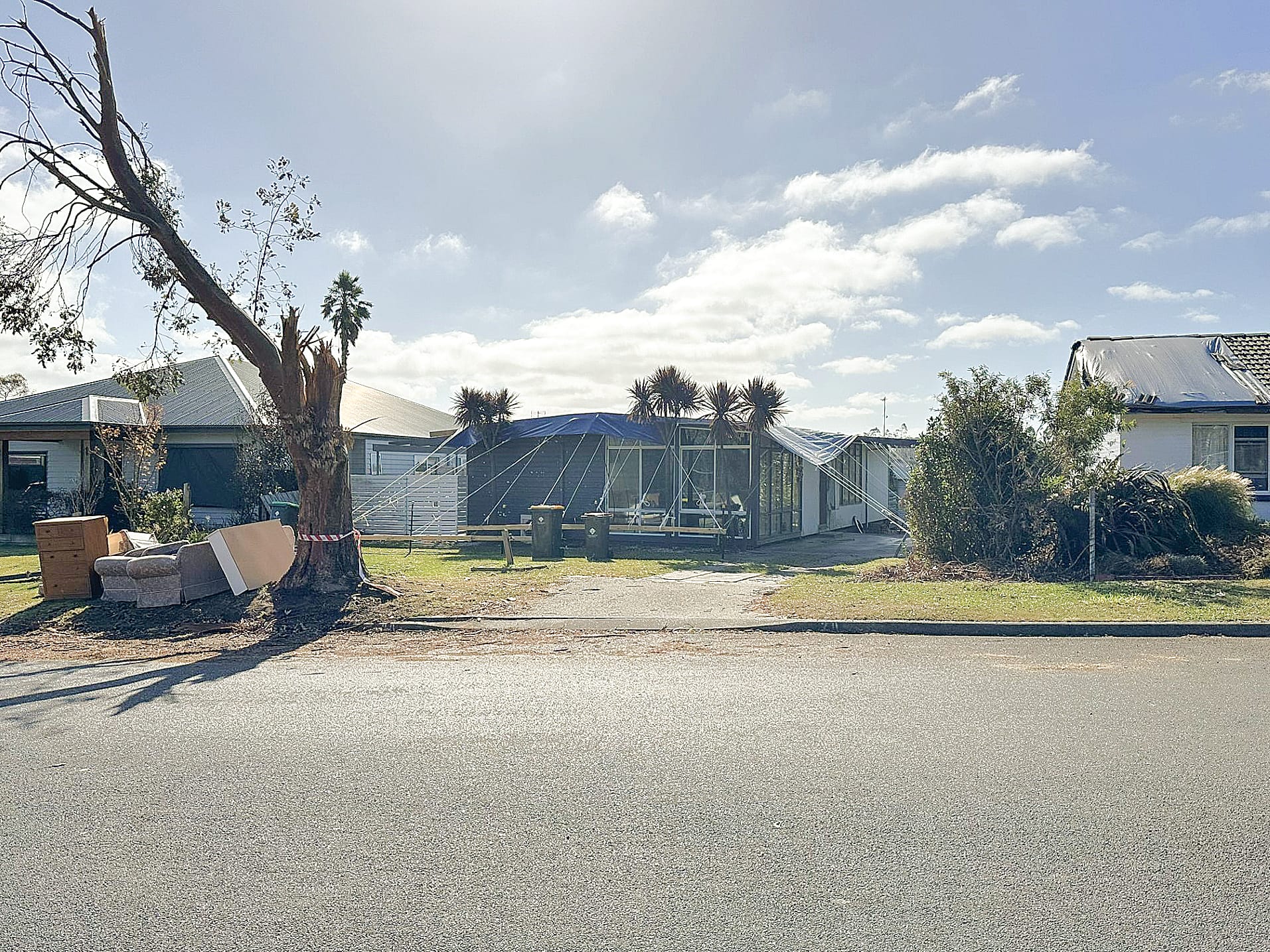 A tarp covers the entire roof of a home in Mirboo North. ob04_1024