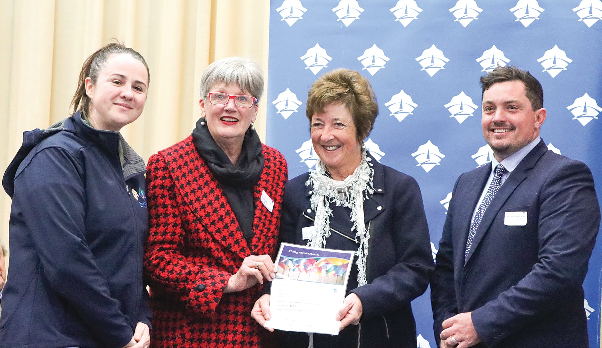 Marge Arnup and Trish Steele of Fish Creek Memorial Hall Association accept $5000 towards (chairs?), with Mayor Clare Williams and Cr Nathan Hersey. A02_3124