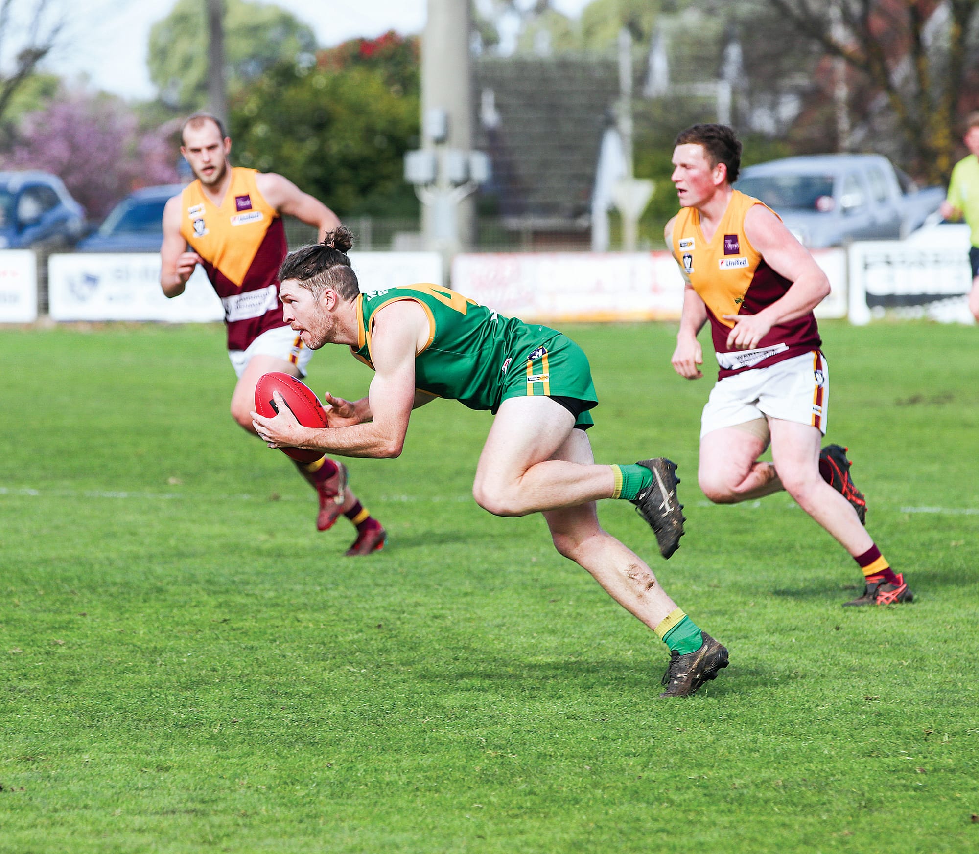 Cam Stone gets the ball out of the battle with Drouin and handballs it off carefully in the first half. Z38_3422
