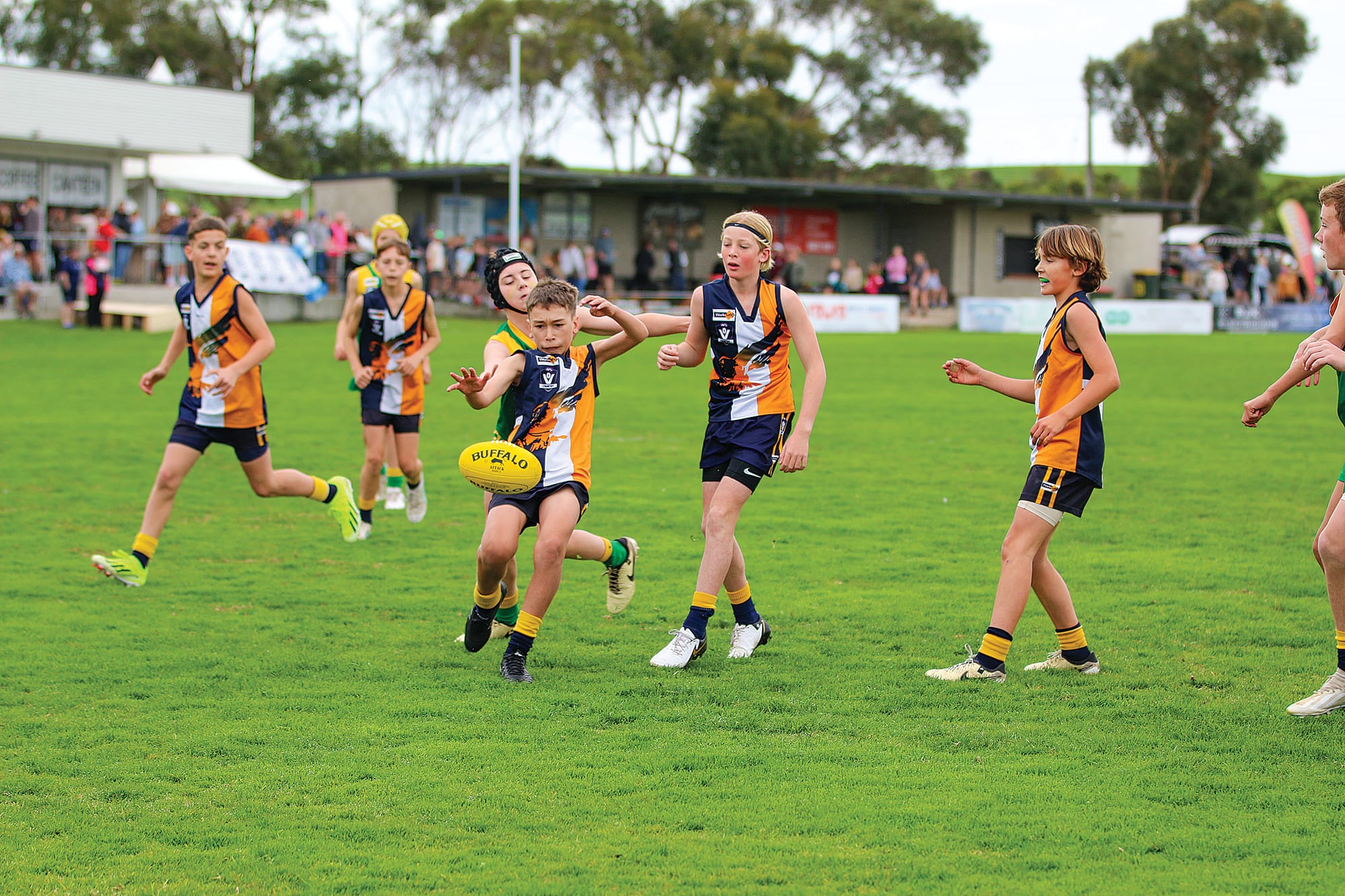 Ryder Brannaghan boots the ball into Inverloch-Kongwak’s forward 50 in the U12 mixed grand final.