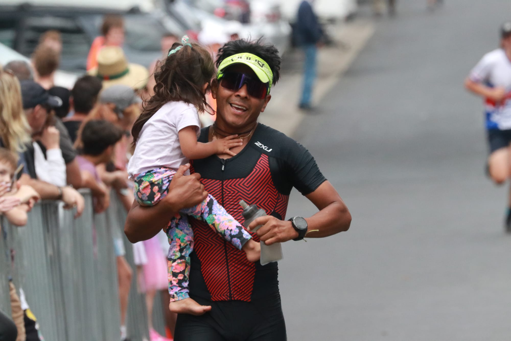 Elder Bejar&nbsp;runs through the Cowes Classic finish line with two-year-old daughter Mia.