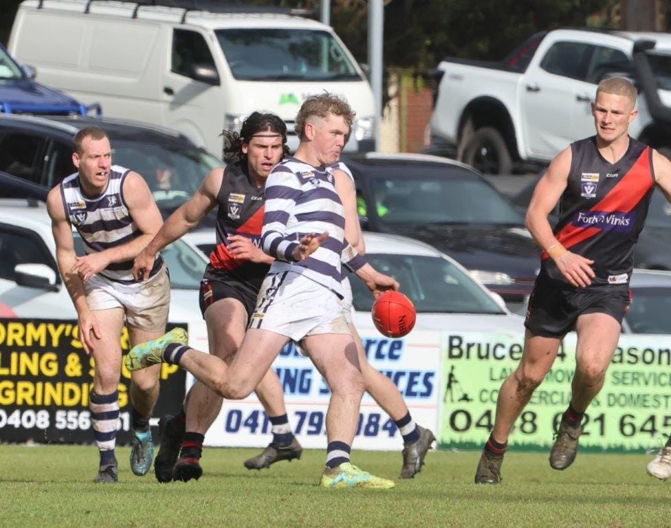 One of the Woodside Wildcats’ best players in the grand final, Adam Janssen, kicks the ball clear of the TTU scoring zone during a crucial defensive effort in the third quarter,