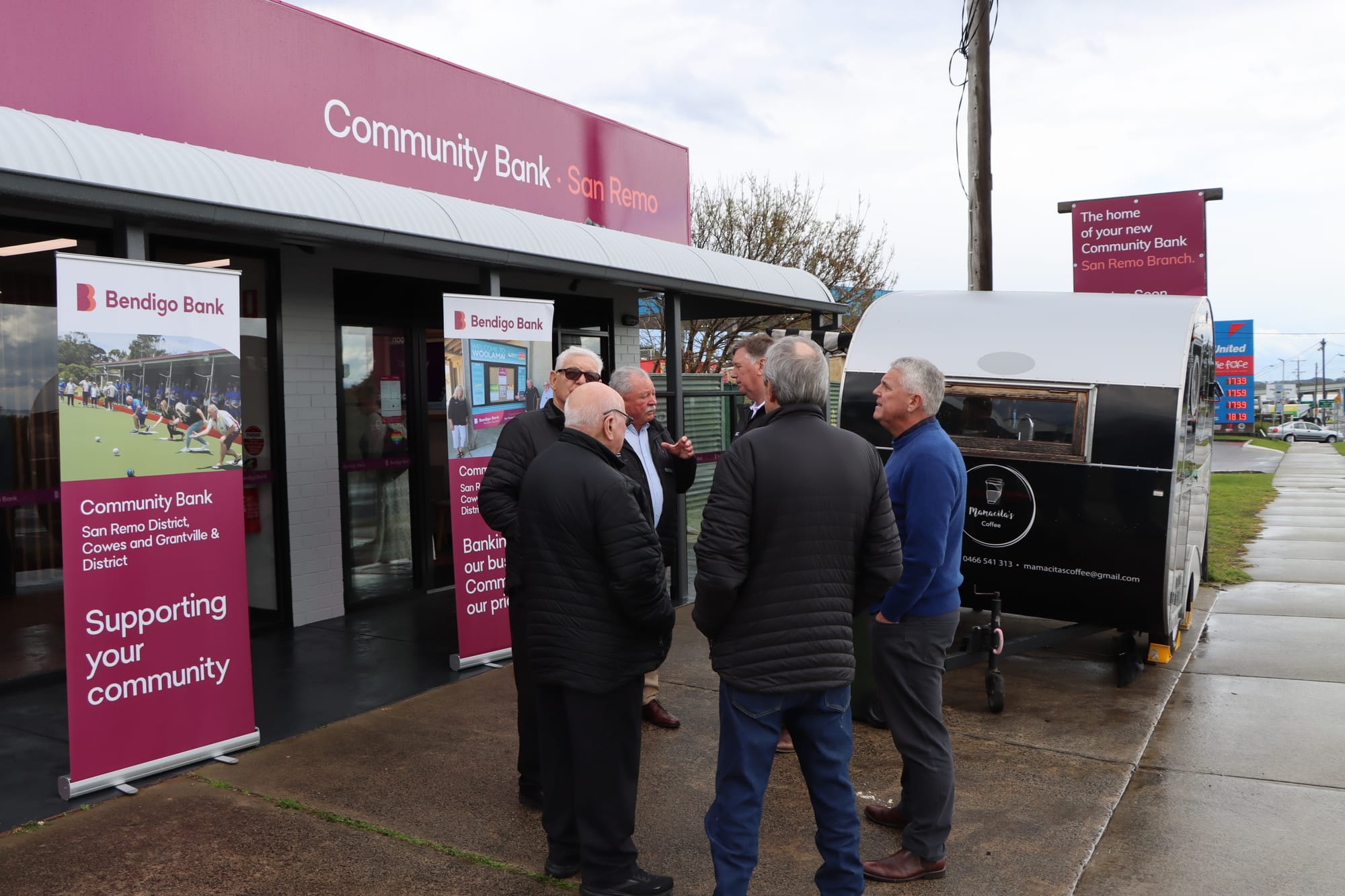 A few of those at the opening of Bendigo Community Bank San Remo’s new office enjoy a moment outside while the rain takes a break. 