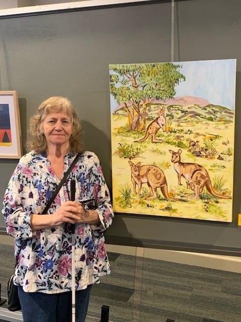 Cathy Wade with her art work Kangaroos