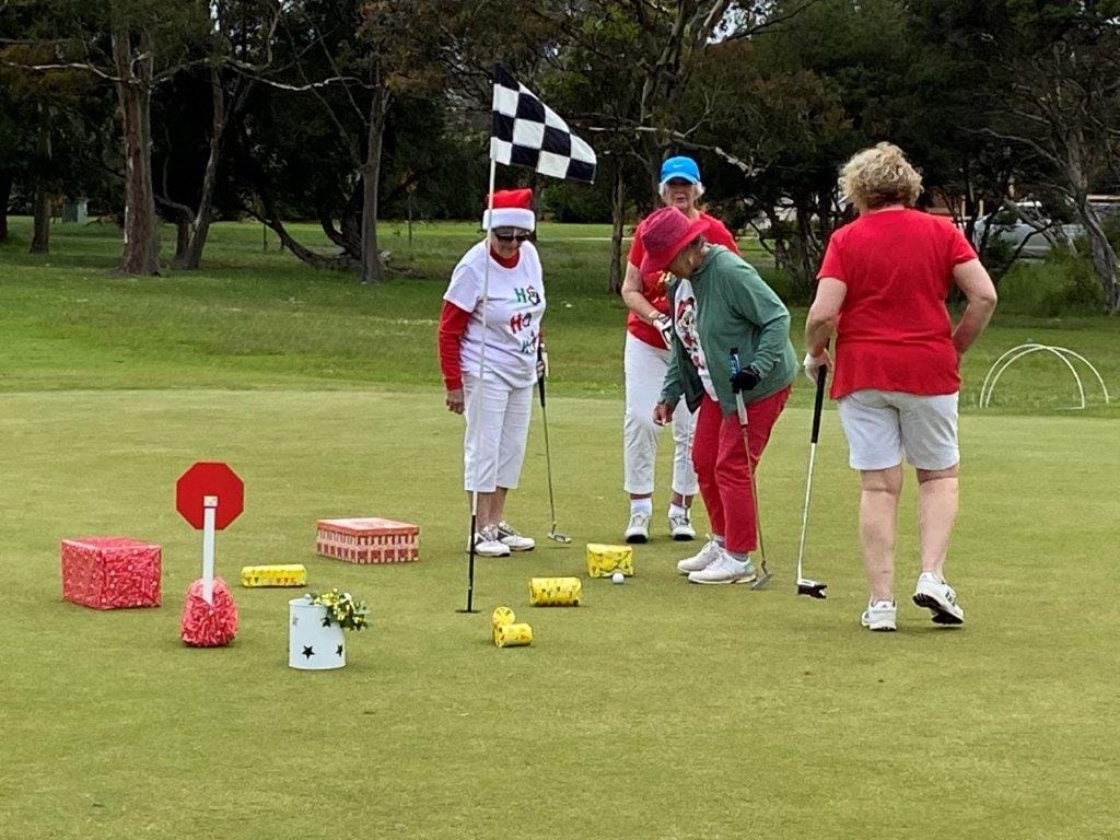 It's hard enough without the Christmas obstacles! Norma Corr, Pam May, Judy Magill and Jo Disher put around the Christmas gifts and into the hole in a novelty Christmas event at Cowes golf club during the week.