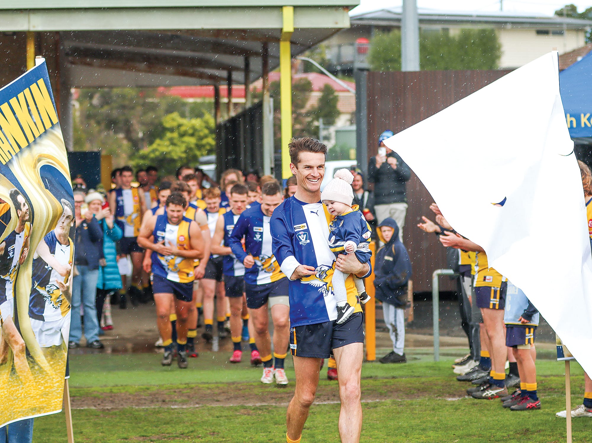 Lewis Rankin enjoys the moment after going through the banner marking his 200th senior game. A61_3325