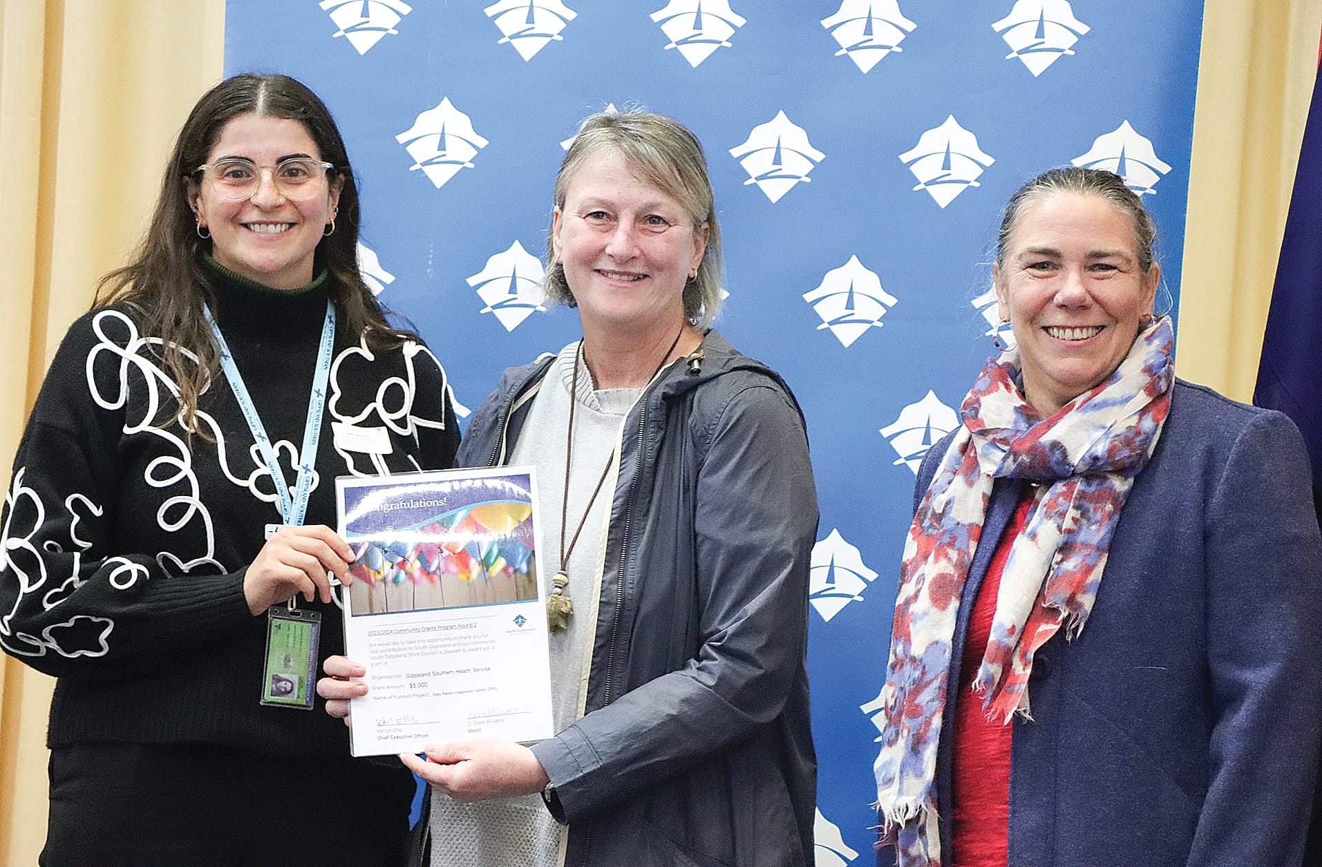 Alex Monacello and Sandra Panagiris of Gippsland Southern Health Service are pleased with $5,000 towards the Dolly Parton Imagination Library, with Cr Sarah Gilligan. A09_3124