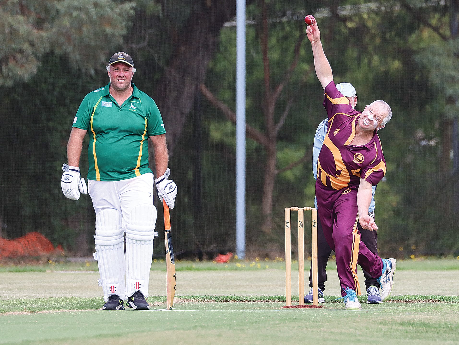 OMK’s B2 skipper and club president Russell White sends one down in the grand final, with non-striker and man of the match looking on.