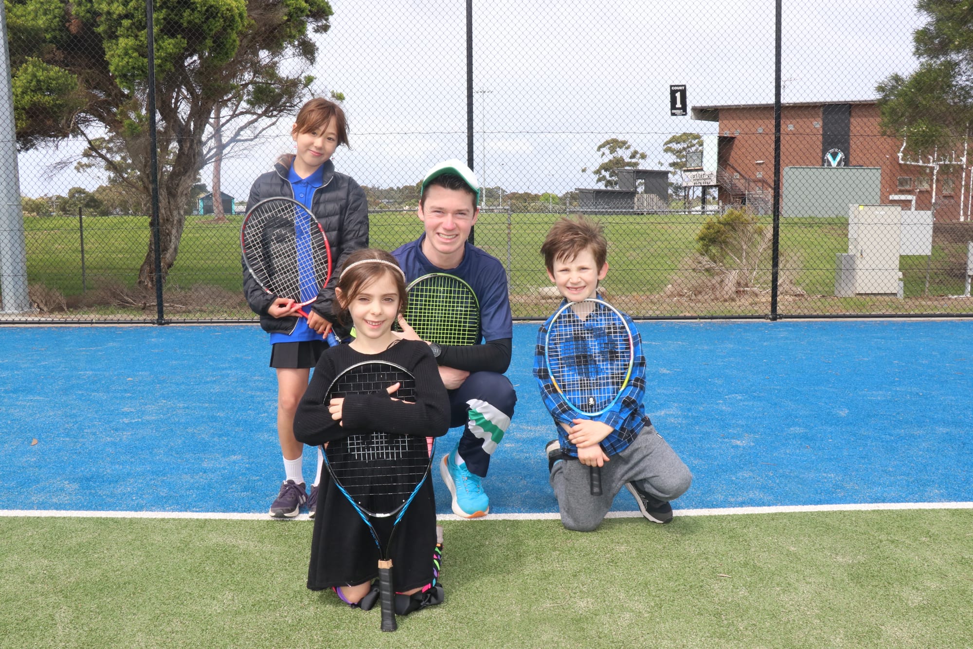 ITM junior tennis coach Luke Nicholson held a coaching session with juniors L to R Sola, Isabelle (front) and Vincenzo at the official grand opening of the new Wonthaggi tennis pavilion. 