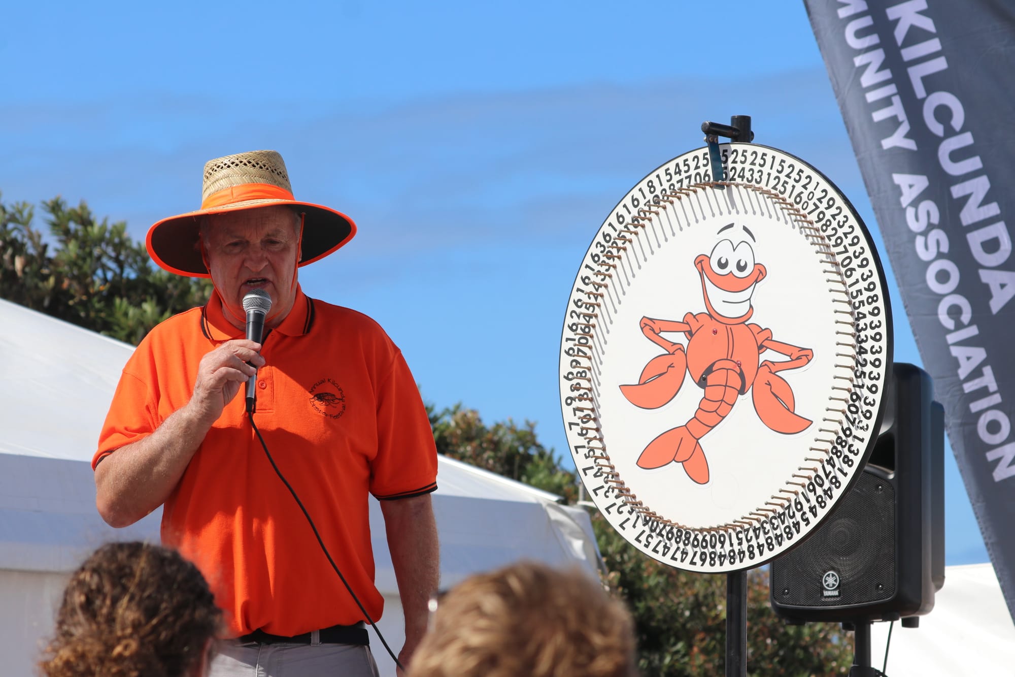 John Duscher hosting the spinning wheel at the 2024 lobster festival. 