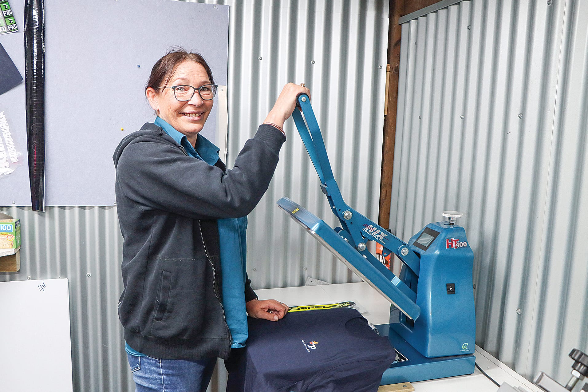 Cherie Pritchett is one of the loyal staff members continuing at Countrywide Clothing & Safety Supplies, shown using the logo machine. A20_1625