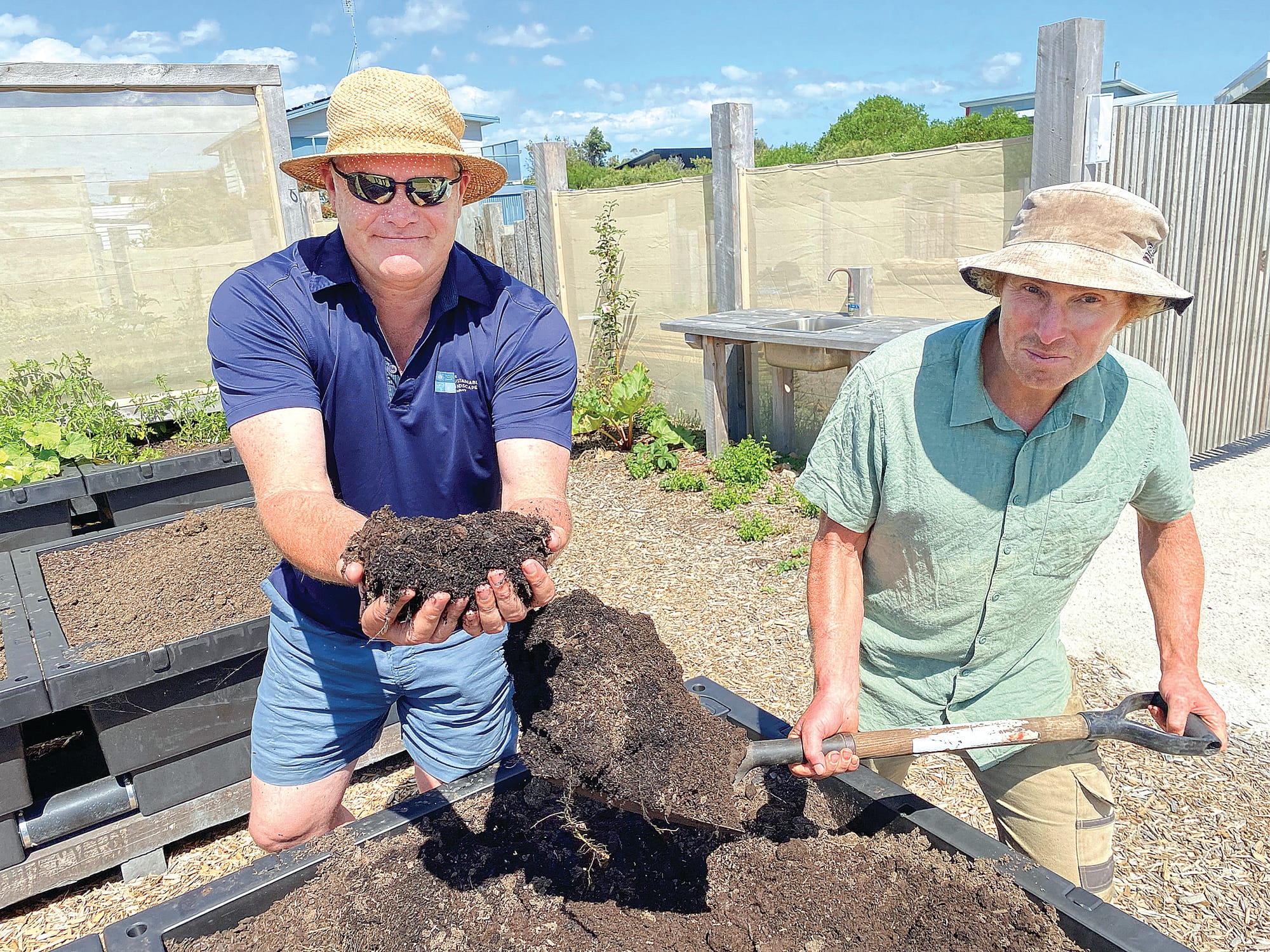 The addition of a compost hub as part of The Cape Community Farm project has energised the members’ vegie plots. The Cape director Brendan Condon and Community Farm Manager Adrian James demonstrate the quality of the compost, made from residents’ organic waste and locally-sourced horse, cow and chicken manure.