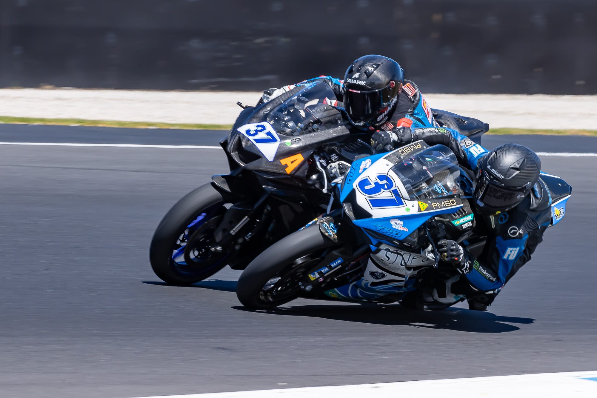 In what proved to be the race winning move Jack Mahaffy (37) slips under Marianos Nikolis at turn five. 