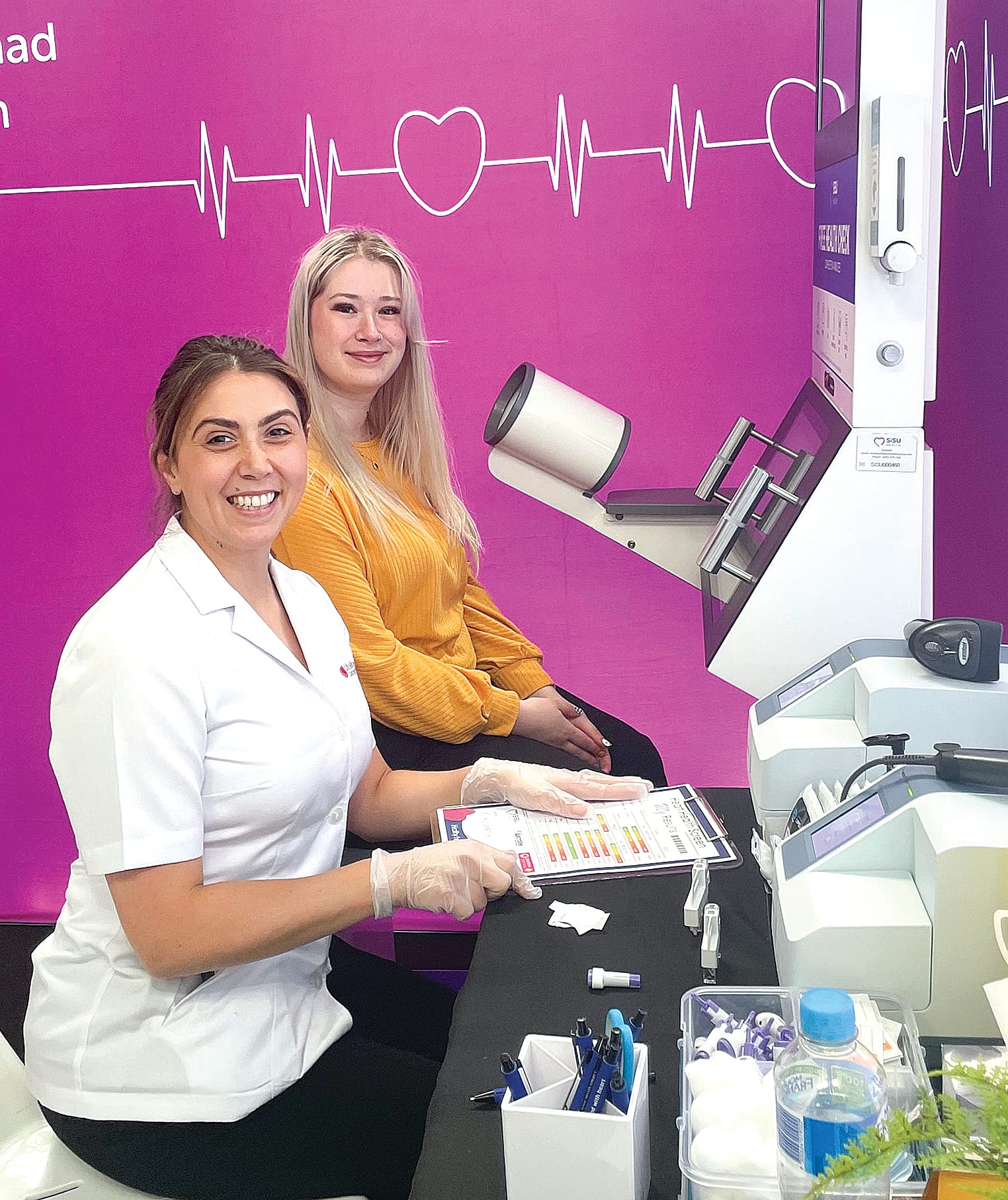 Participant Heather Clifford is taken through the heart screening process by pharmacist Amy Sabatin.